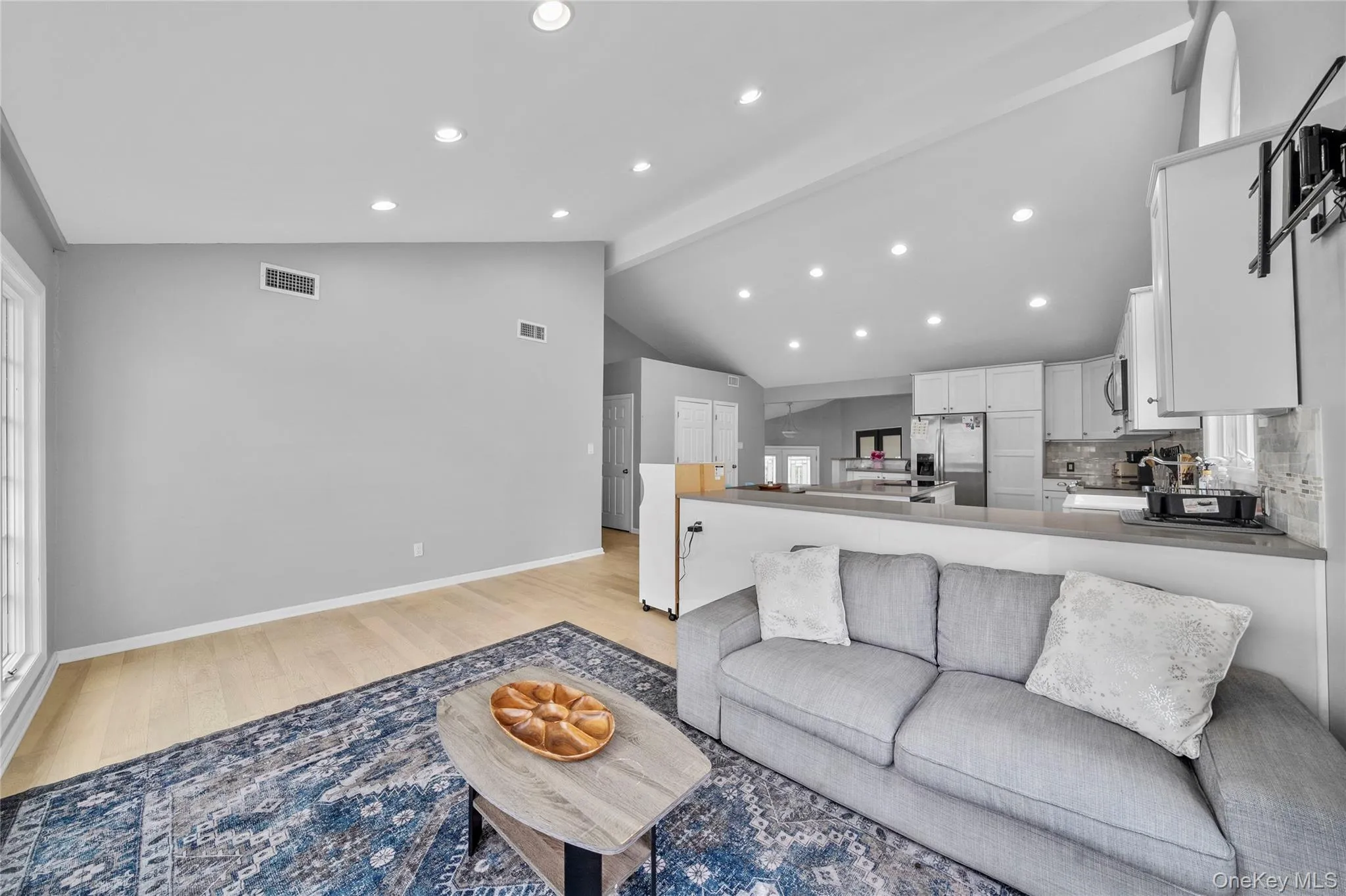 Living room featuring light wood-type flooring, recessed lighting, and healthy amount of natural light Living room featuring light wood-type flooring, recessed lighting, and healthy amount of natural light