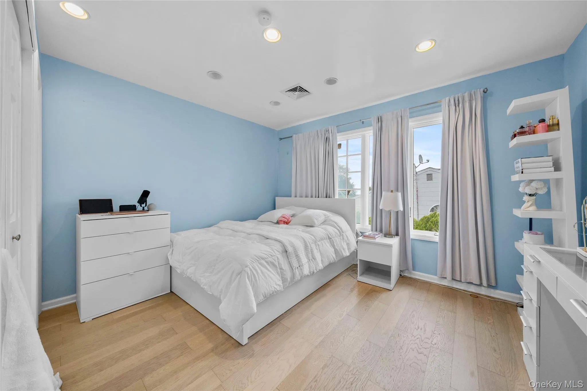 Bedroom with light wood-type flooring and recessed lighting Bedroom with light wood-type flooring and recessed lighting