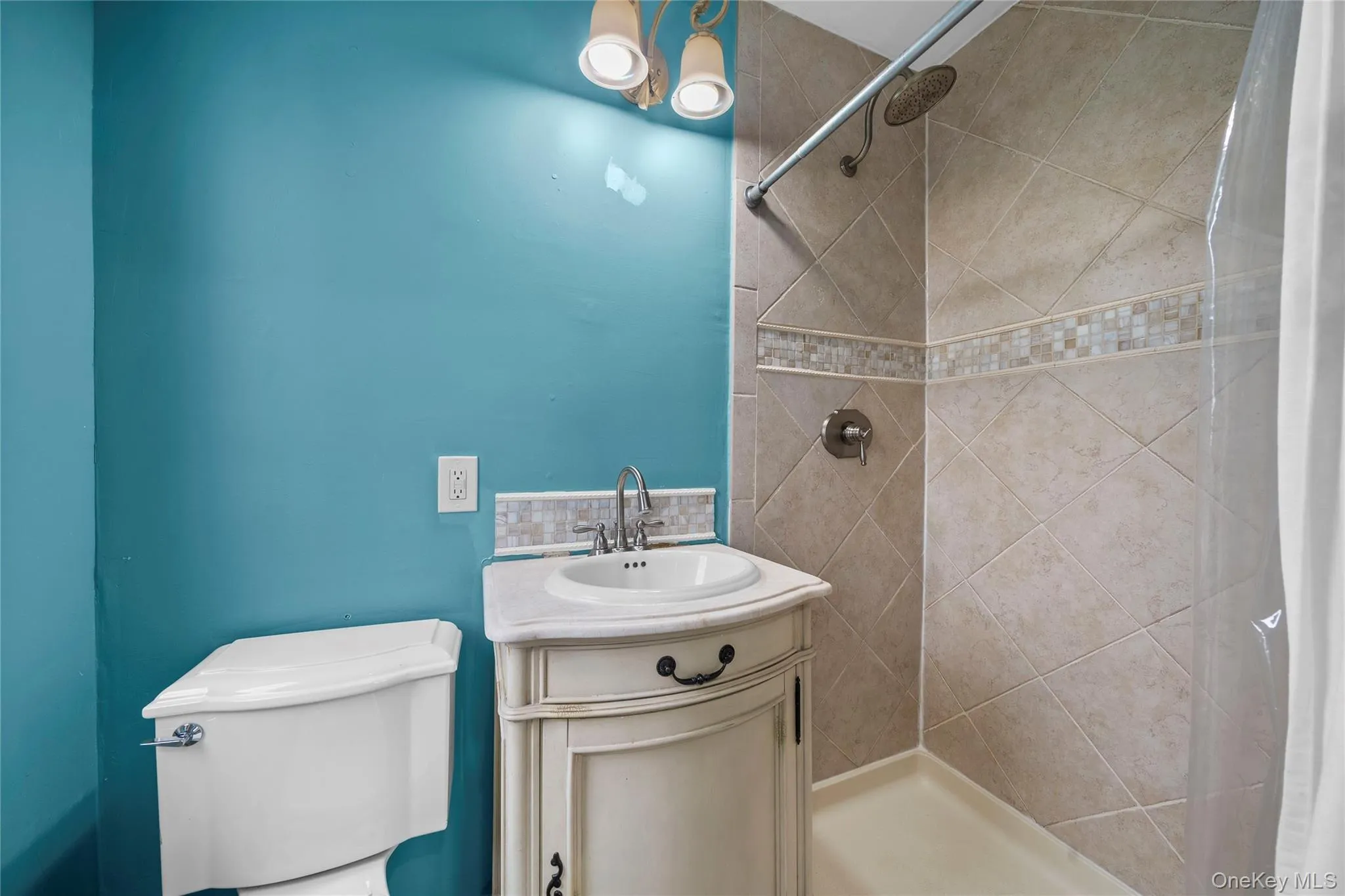 Bathroom featuring a stall shower and vanity Bathroom featuring a stall shower and vanity
