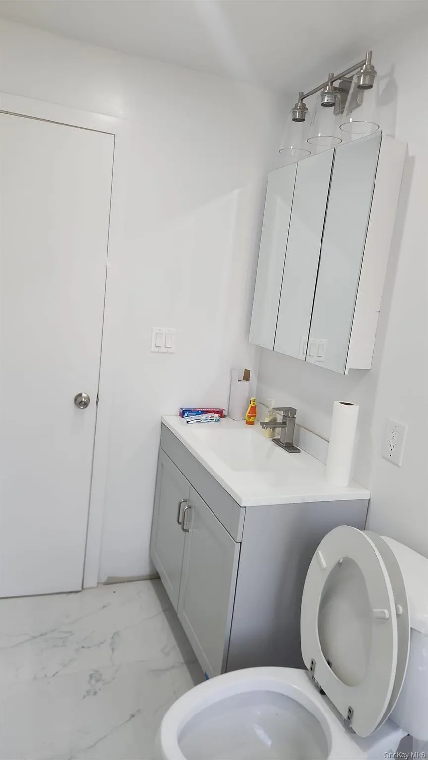 Bathroom with vanity and light marble finish floors Bathroom with vanity and light marble finish floors
