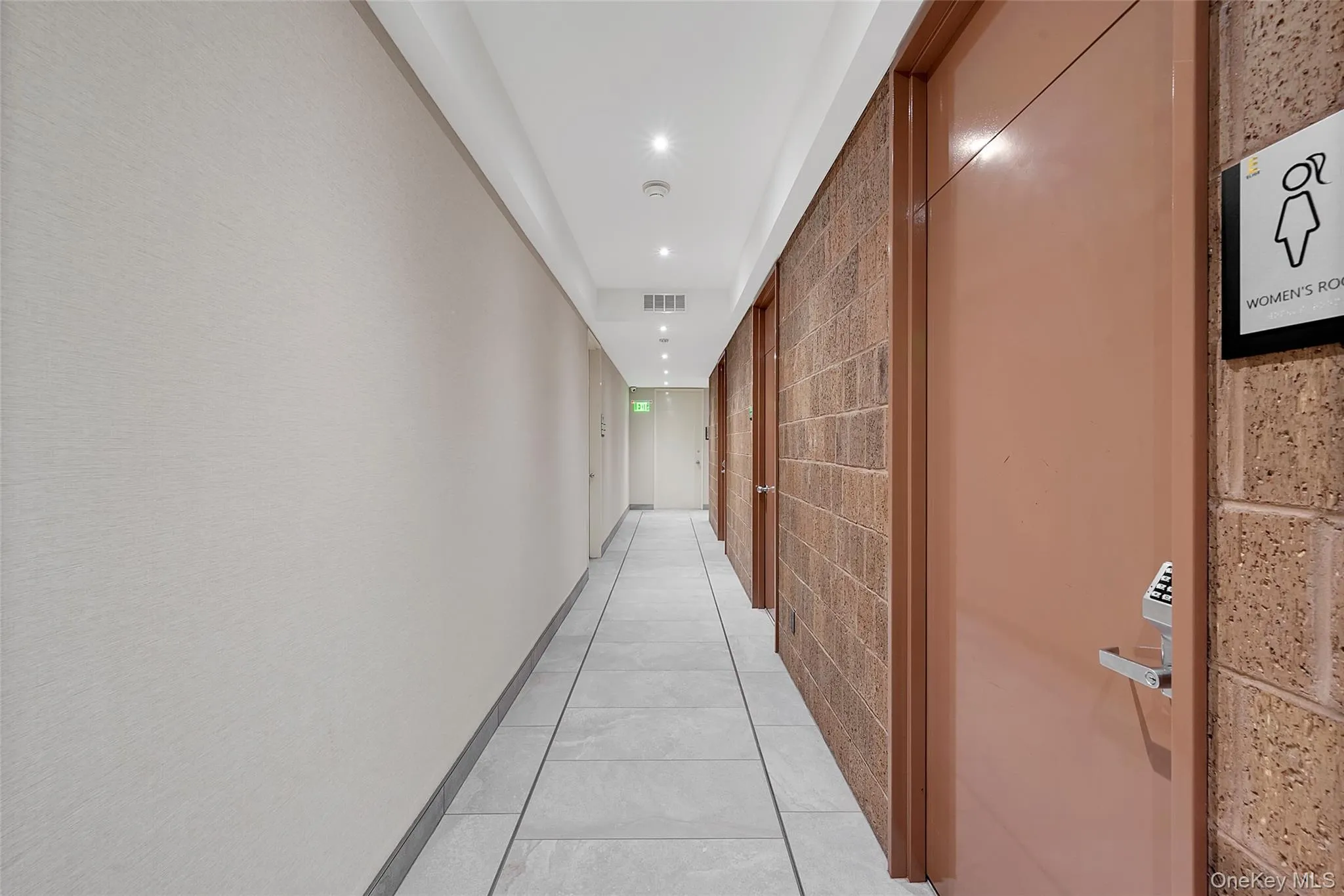 Hall with light tile patterned flooring and recessed lighting Hall with light tile patterned flooring and recessed lighting