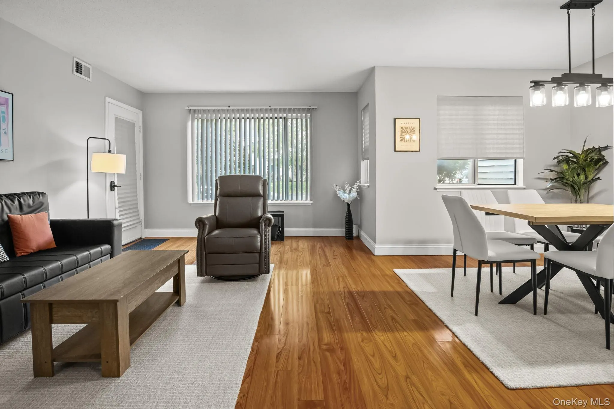 Large windows frame peaceful greenery and enhance the airy flow of this thoughtfully designed living and dining area. Large windows frame peaceful greenery and enhance the airy flow of this thoughtfully designed living and dining area.