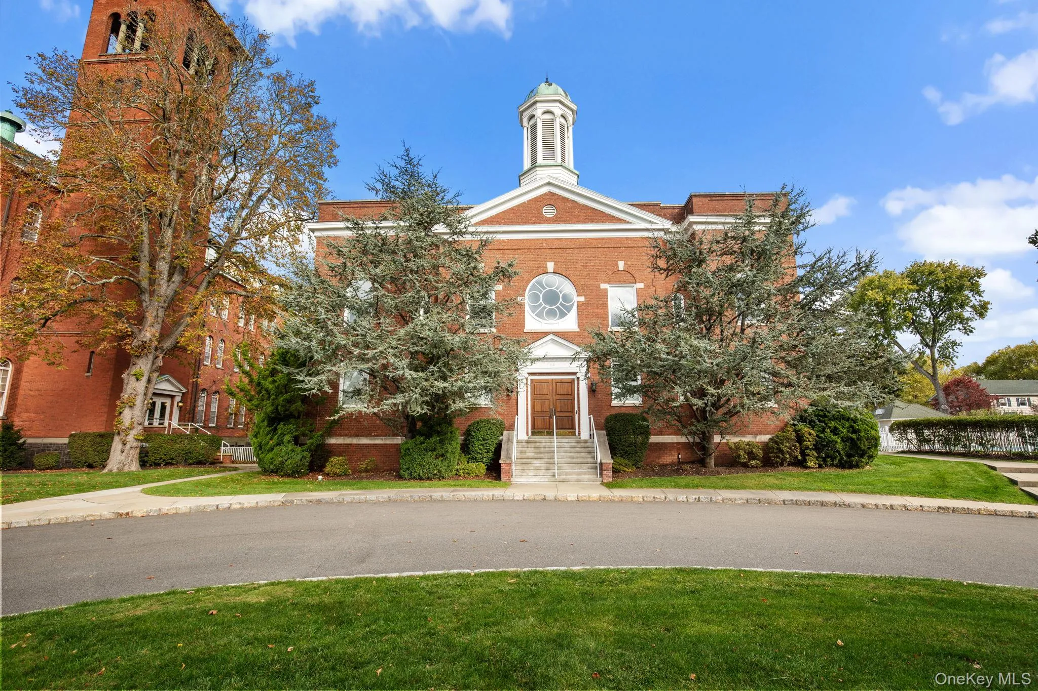The grand brick clubhouse features classic architecture, a columned entrance, and lush landscaping—welcoming you to the heart of the Chapel Hill community. The grand brick clubhouse features classic architecture, a columned entrance, and lush landscaping—welcoming you to the heart of the Chapel Hill community.