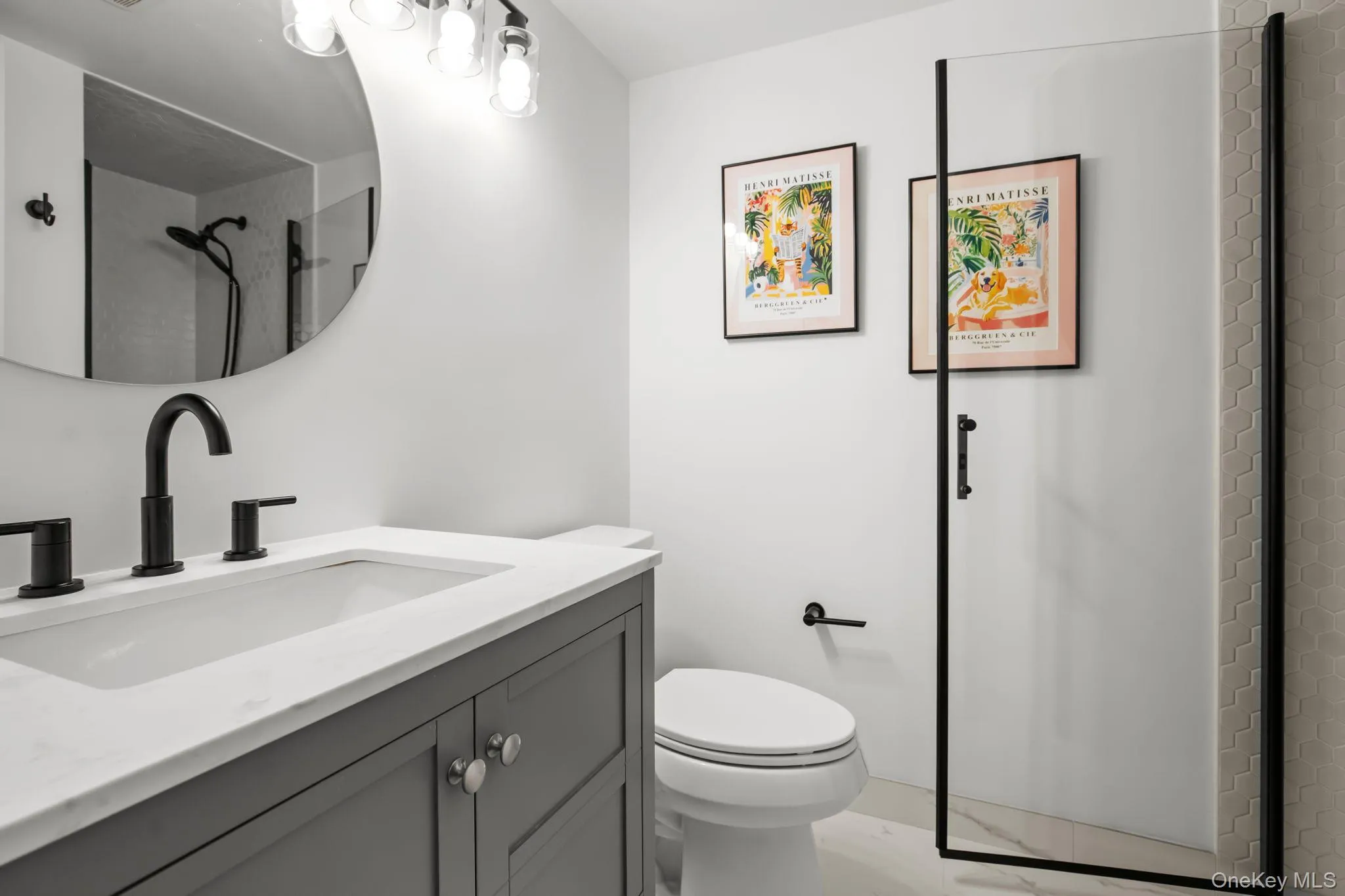 Crisp finishes, a glass shower enclosure, and stylish tilework create a spa-like atmosphere in this newly refreshed full bathroom. Crisp finishes, a glass shower enclosure, and stylish tilework create a spa-like atmosphere in this newly refreshed full bathroom.