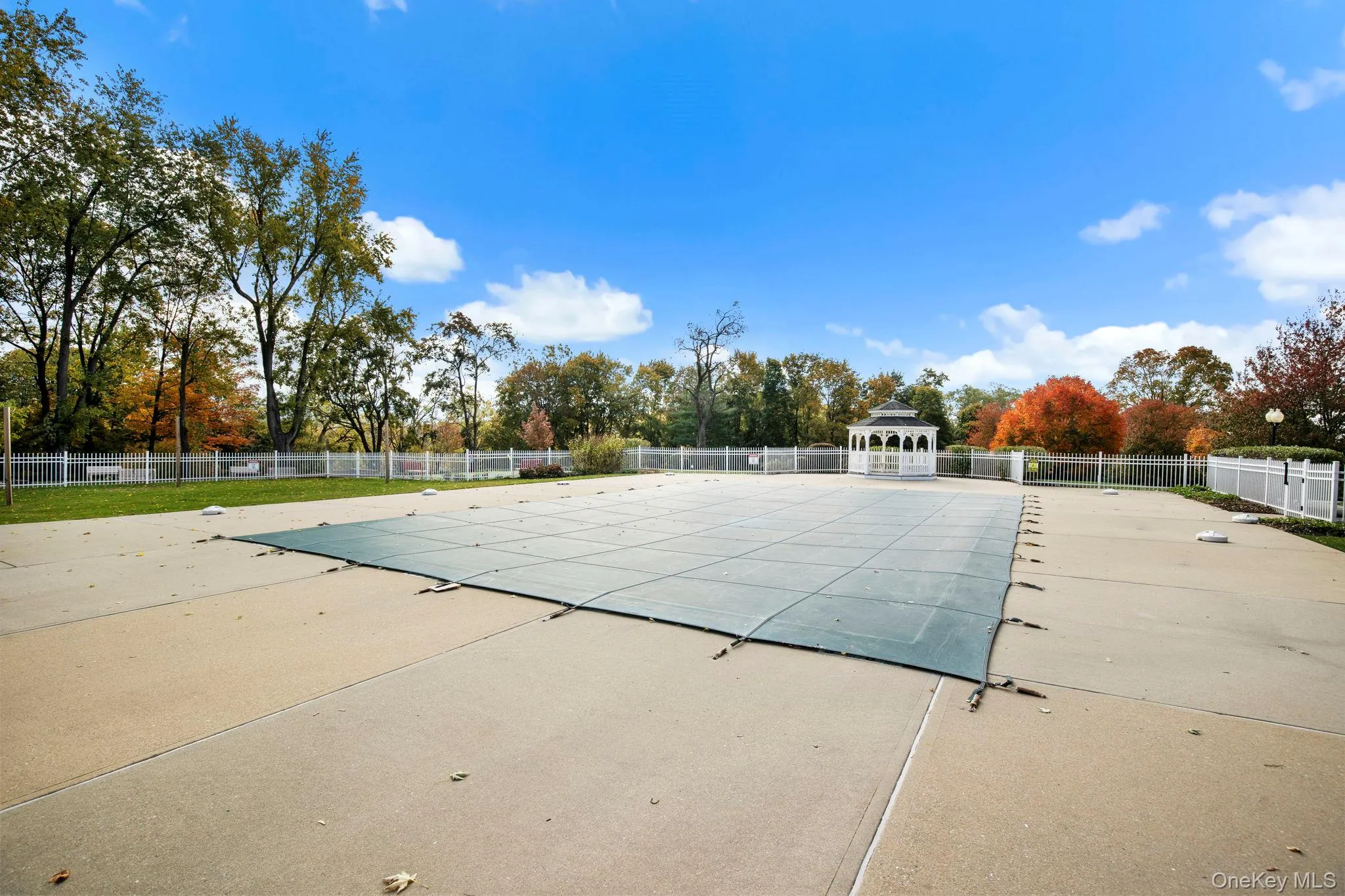 Residents enjoy access to a sparkling inground pool surrounded by a spacious sundeck and peaceful landscaped views. Residents enjoy access to a sparkling inground pool surrounded by a spacious sundeck and peaceful landscaped views.