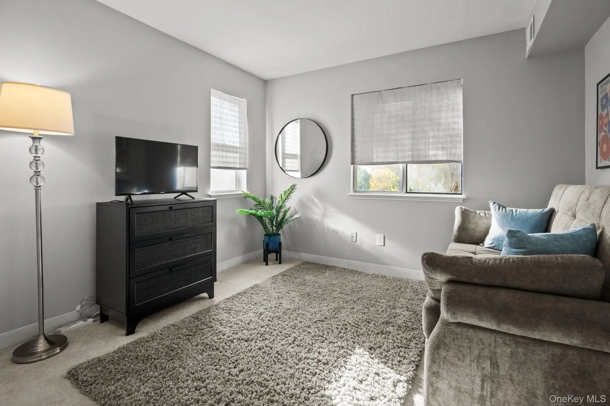 The versatile second bedroom offers soft natural light, plush carpeting, and flexible space ideal for a guest room, home office, or creative retreat. The versatile second bedroom offers soft natural light, plush carpeting, and flexible space ideal for a guest room, home office, or creative retreat.