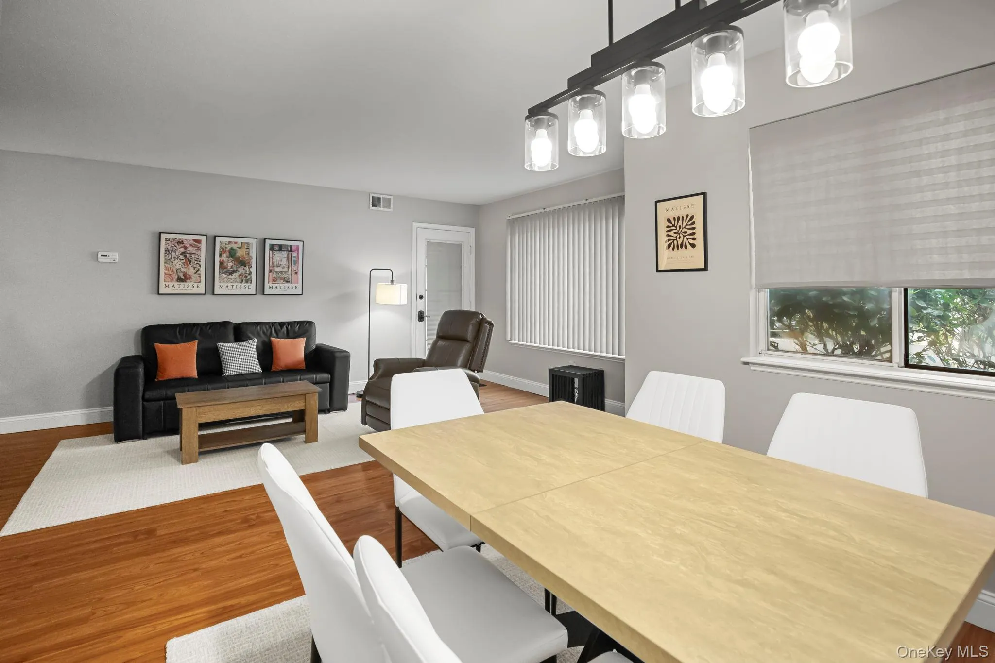 The open-concept design connects the dining and living areas seamlessly, perfect for hosting or relaxing in comfort. The open-concept design connects the dining and living areas seamlessly, perfect for hosting or relaxing in comfort.