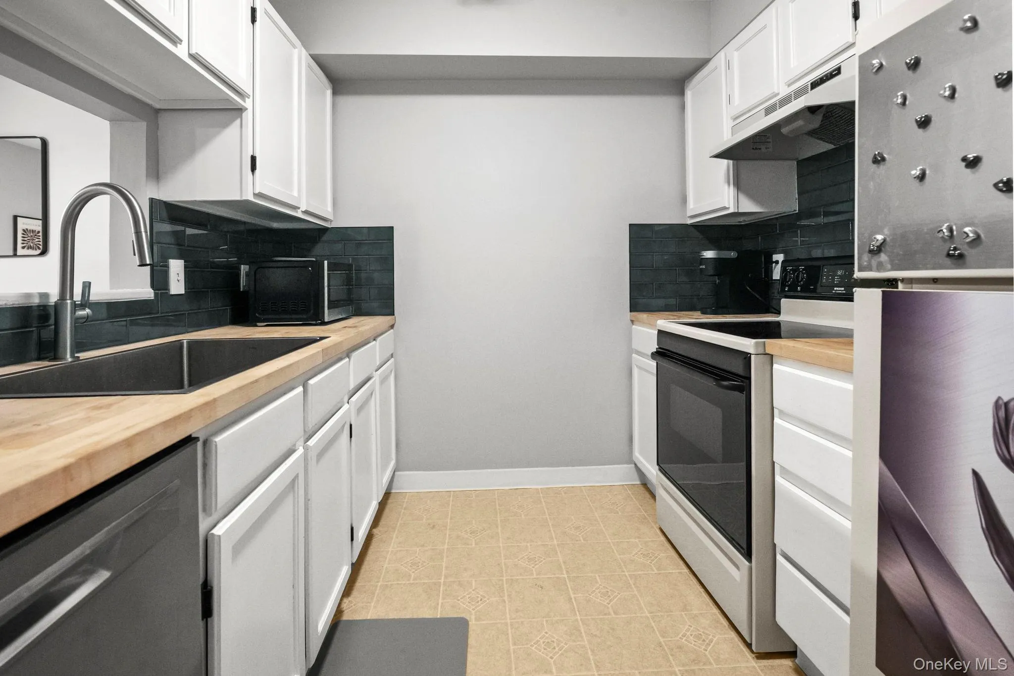 Bright, efficient kitchen with ample cabinet storage, updated finishes, and a timeless design perfect for everyday cooking or entertaining. Bright, efficient kitchen with ample cabinet storage, updated finishes, and a timeless design perfect for everyday cooking or entertaining.