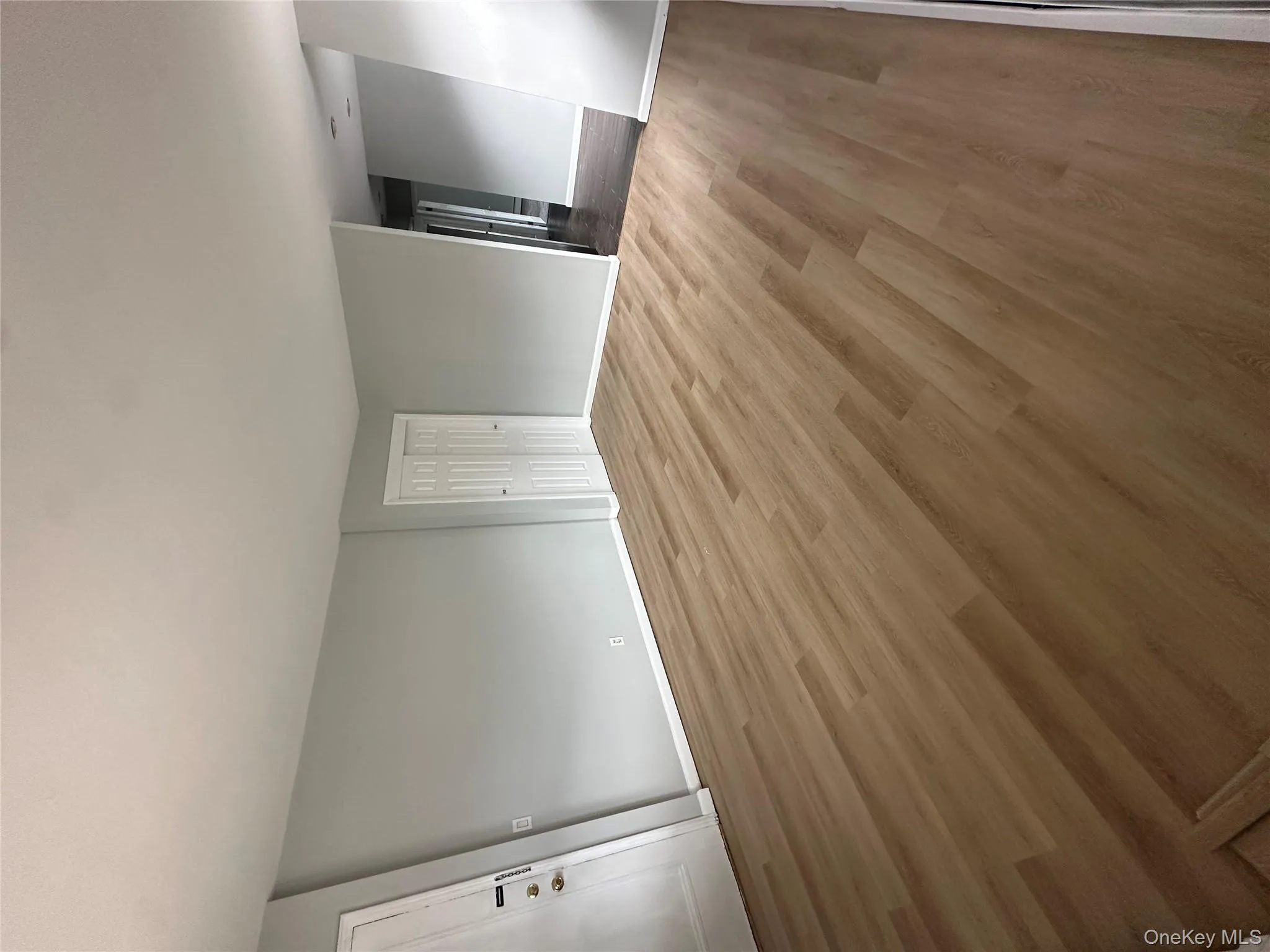 Spare room with wood finished floors and baseboards Spare room with wood finished floors and baseboards