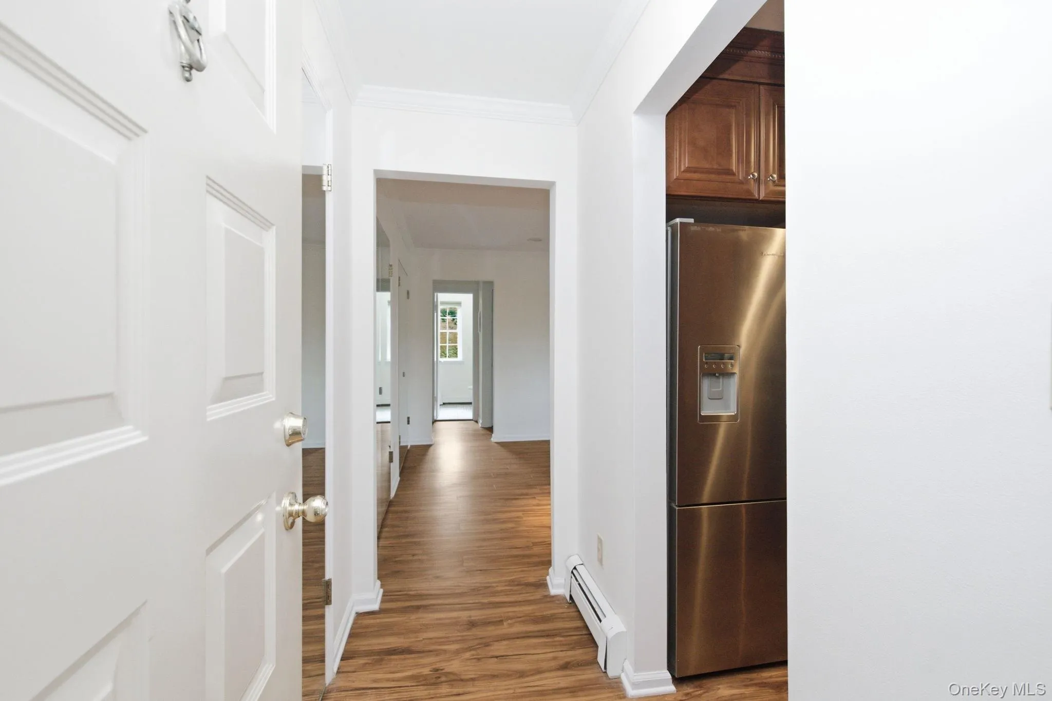 The entry foyer welcomes you with clean white walls, warm hardwood-look planks, and an open corridor that connects every room with light pouring through from both ends of the unit. The entry foyer welcomes you with clean white walls, warm hardwood-look planks, and an open corridor that connects every room with light pouring through from both ends of the unit.