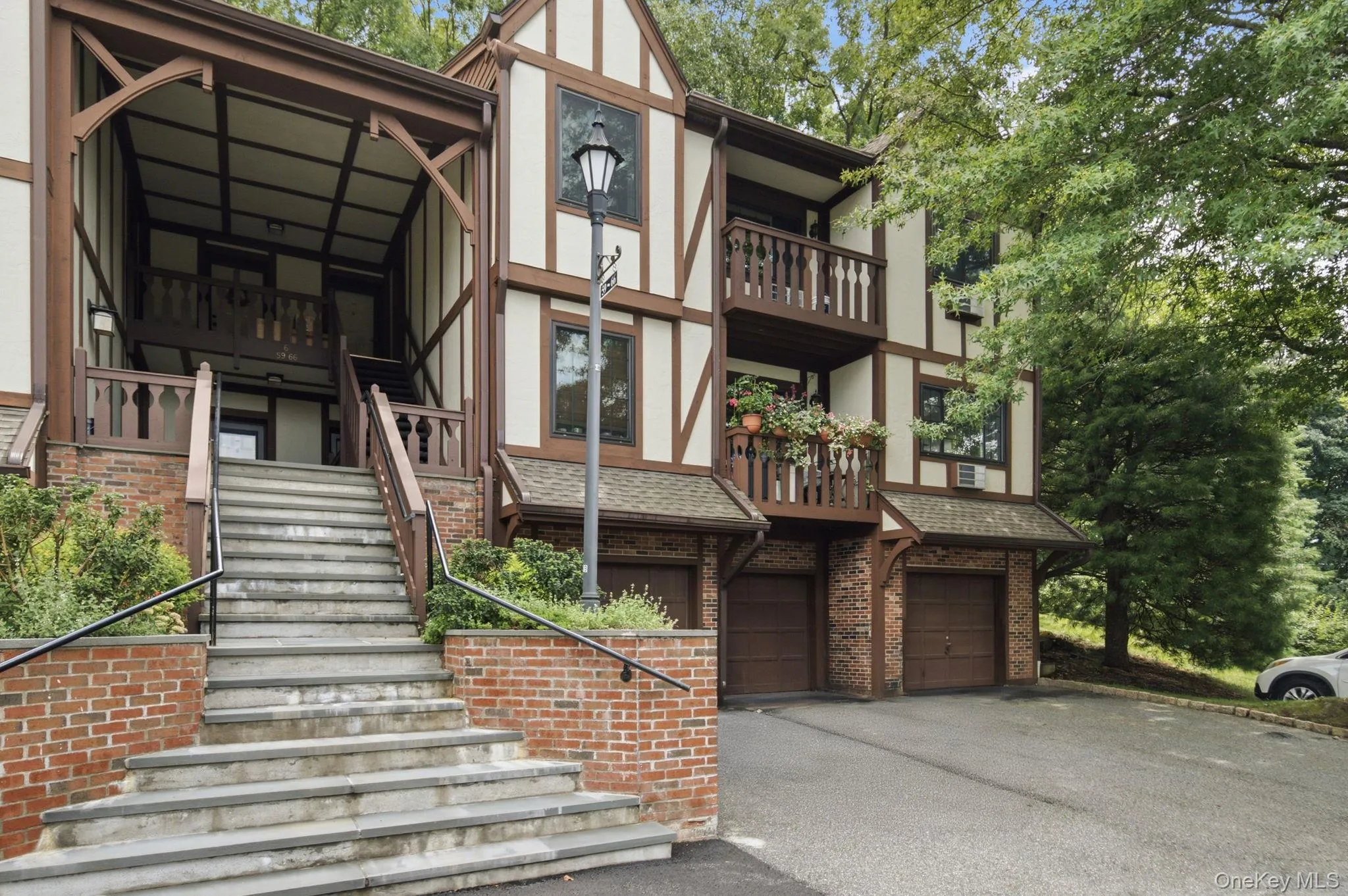 The classic Tudor-style exterior showcases the character and curb appeal that set Foxwood apart, with private garages below, a grand entry staircase, and your own balcony perched above the lush, mature grounds. The classic Tudor-style exterior showcases the character and curb appeal that set Foxwood apart, with private garages below, a grand entry staircase, and your own balcony perched above the lush, mature grounds.