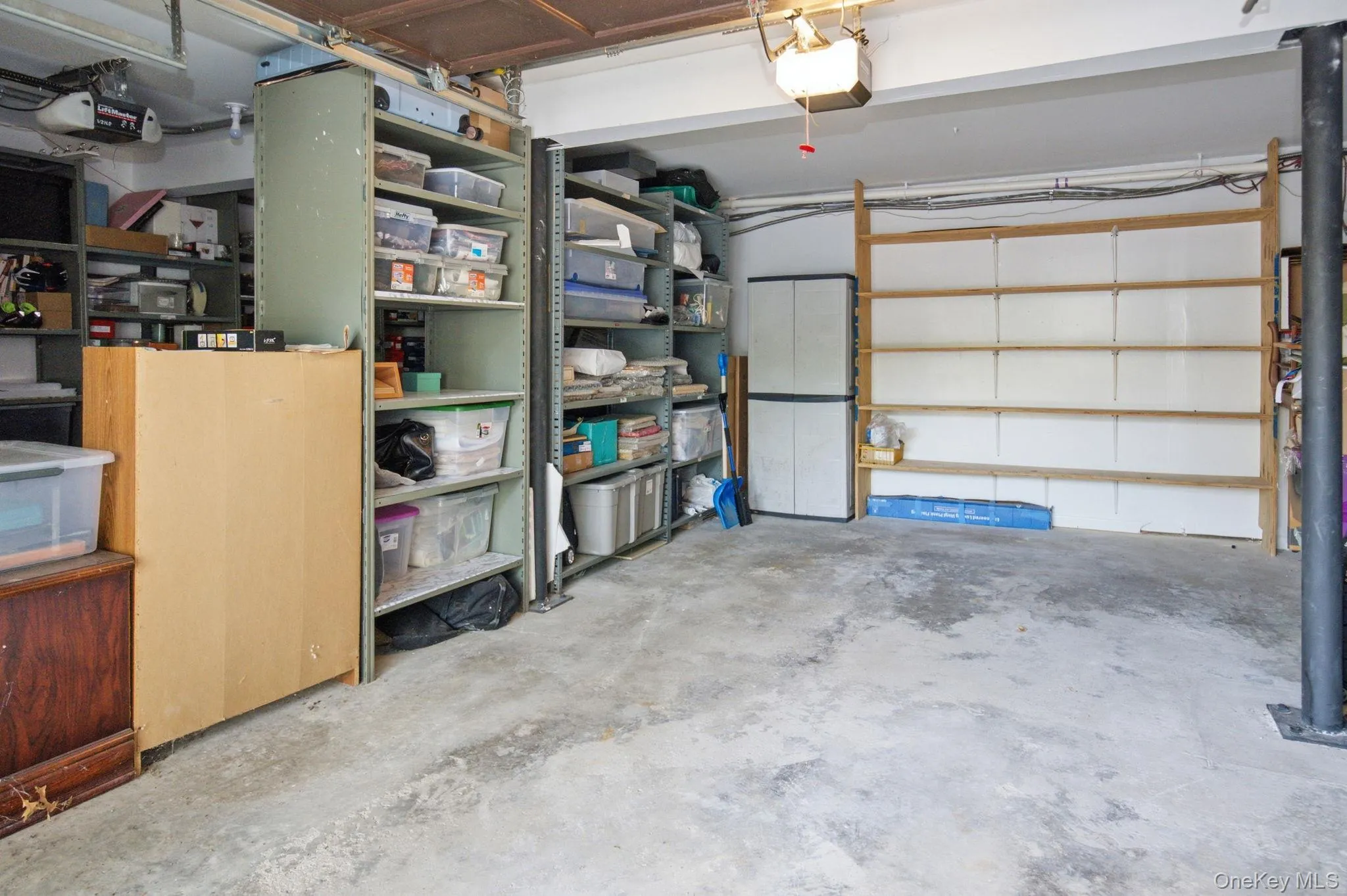 The private garage with opener is a full-size space lined with built-in shelving on multiple walls, offering room for your vehicle plus serious extra storage capacity right at ground level. The private garage with opener is a full-size space lined with built-in shelving on multiple walls, offering room for your vehicle plus serious extra storage capacity right at ground level.