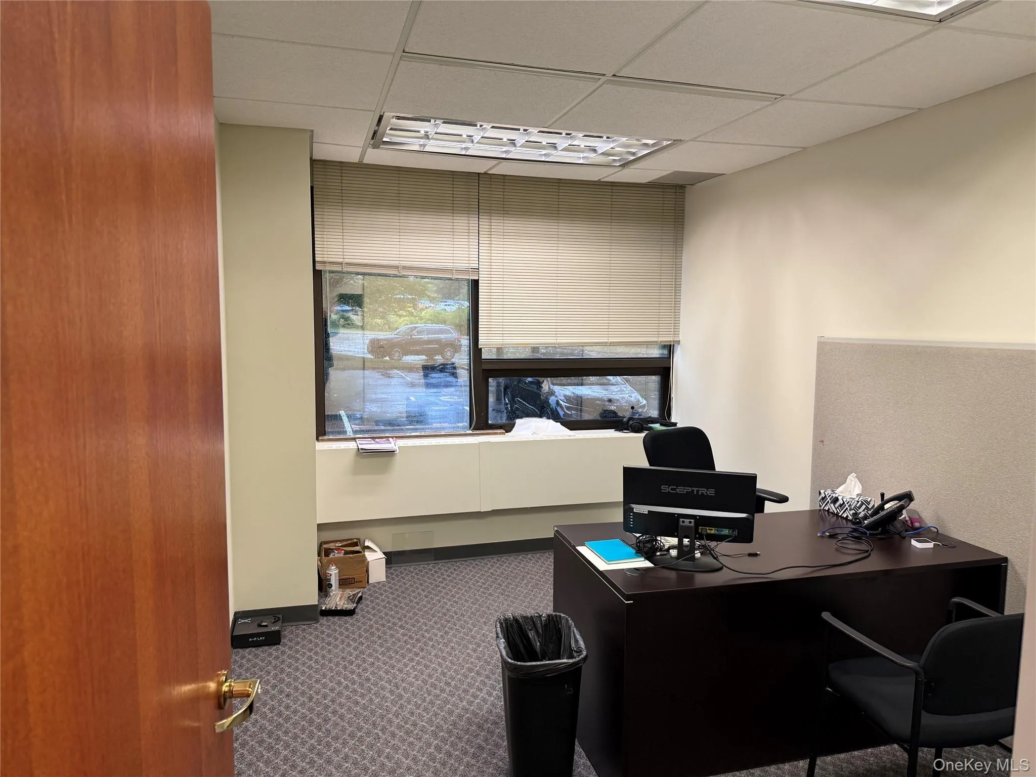 Home office with a paneled ceiling Home office with a paneled ceiling
