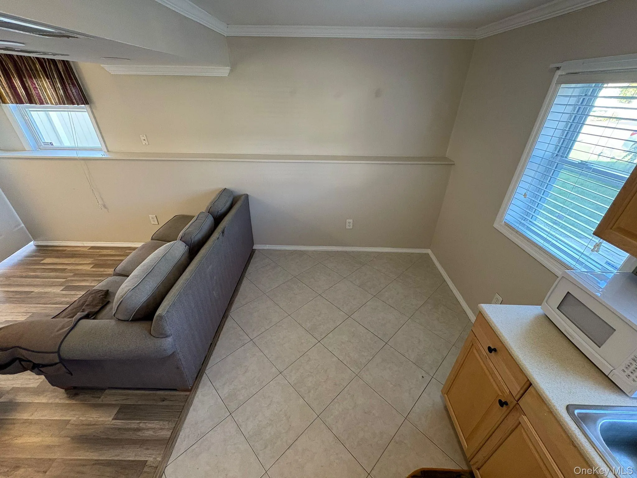 Living room featuring crown molding and light wood-type flooring Living room featuring crown molding and light wood-type flooring