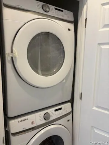 Laundry room featuring stacked washing machine and dryer Laundry room featuring stacked washing machine and dryer