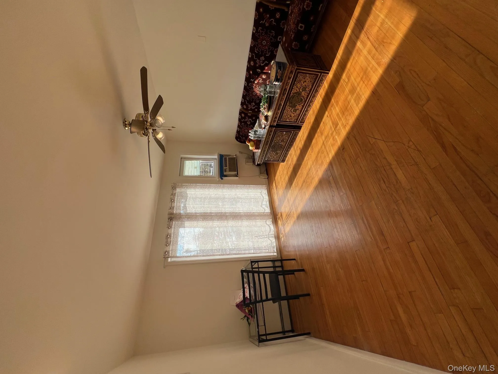 Living room featuring hardwood / wood-style flooring and ceiling fan Living room featuring hardwood / wood-style flooring and ceiling fan