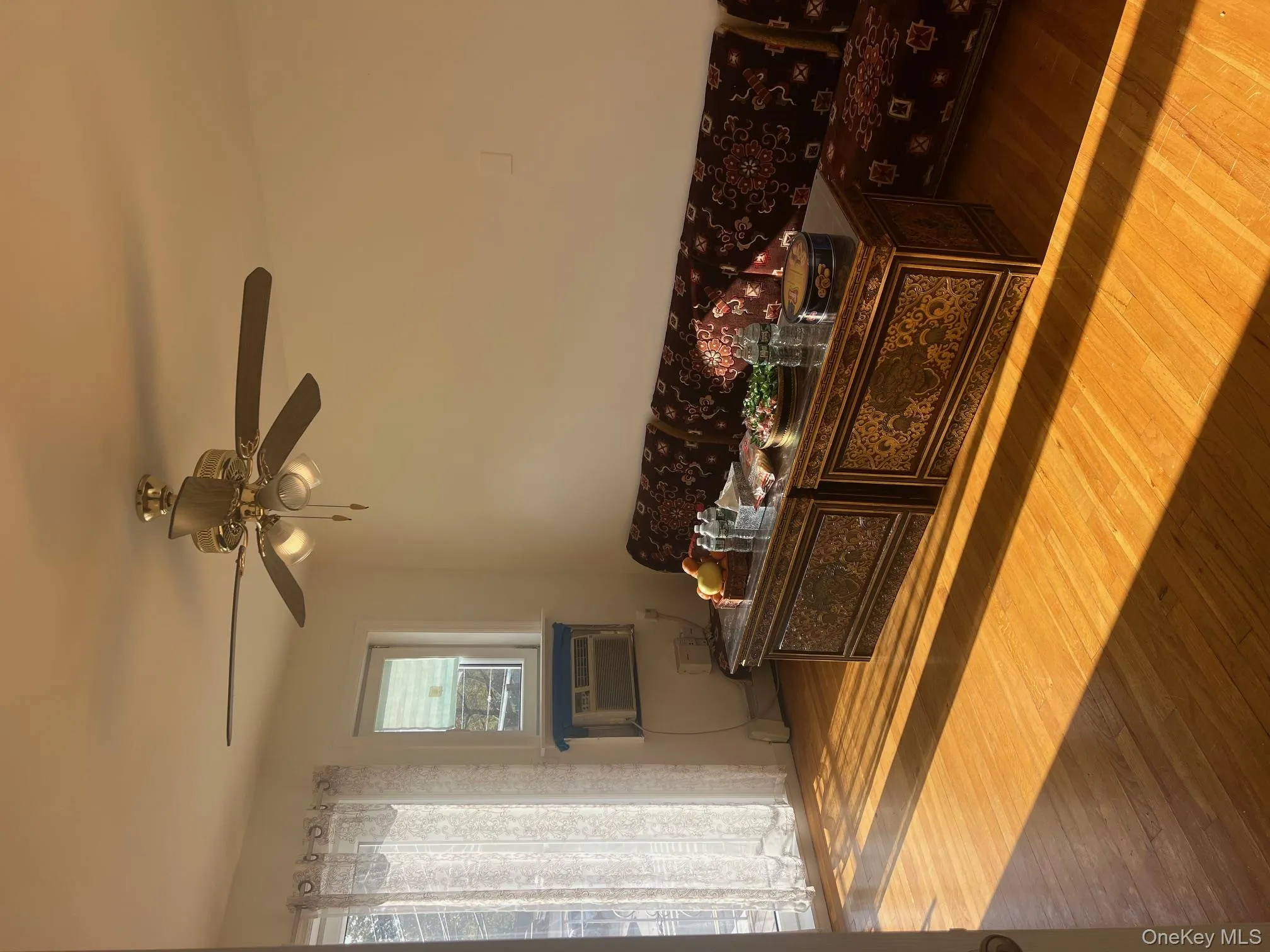 Living room with wood finished floors and ceiling fan Living room with wood finished floors and ceiling fan