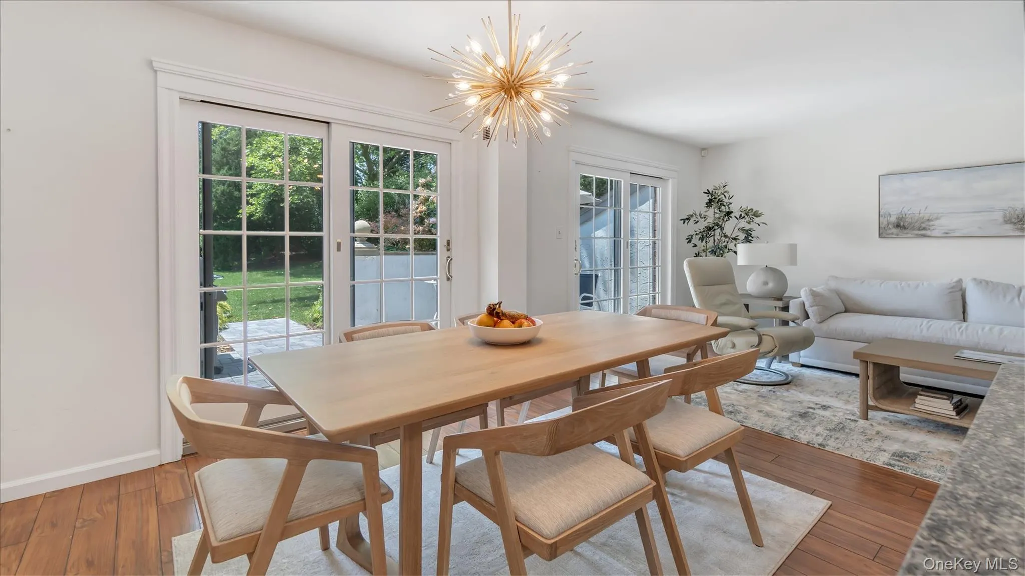Dining area with a chandelier and wood-type flooring Dining area with a chandelier and wood-type flooring