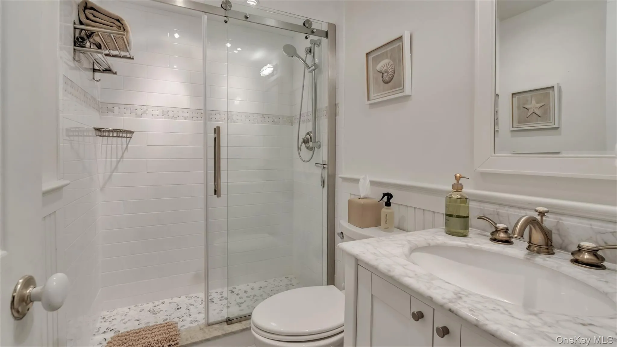 Main Floor Bathroom featuring vanity, a stall shower, and wainscoting Main Floor Bathroom featuring vanity, a stall shower, and wainscoting