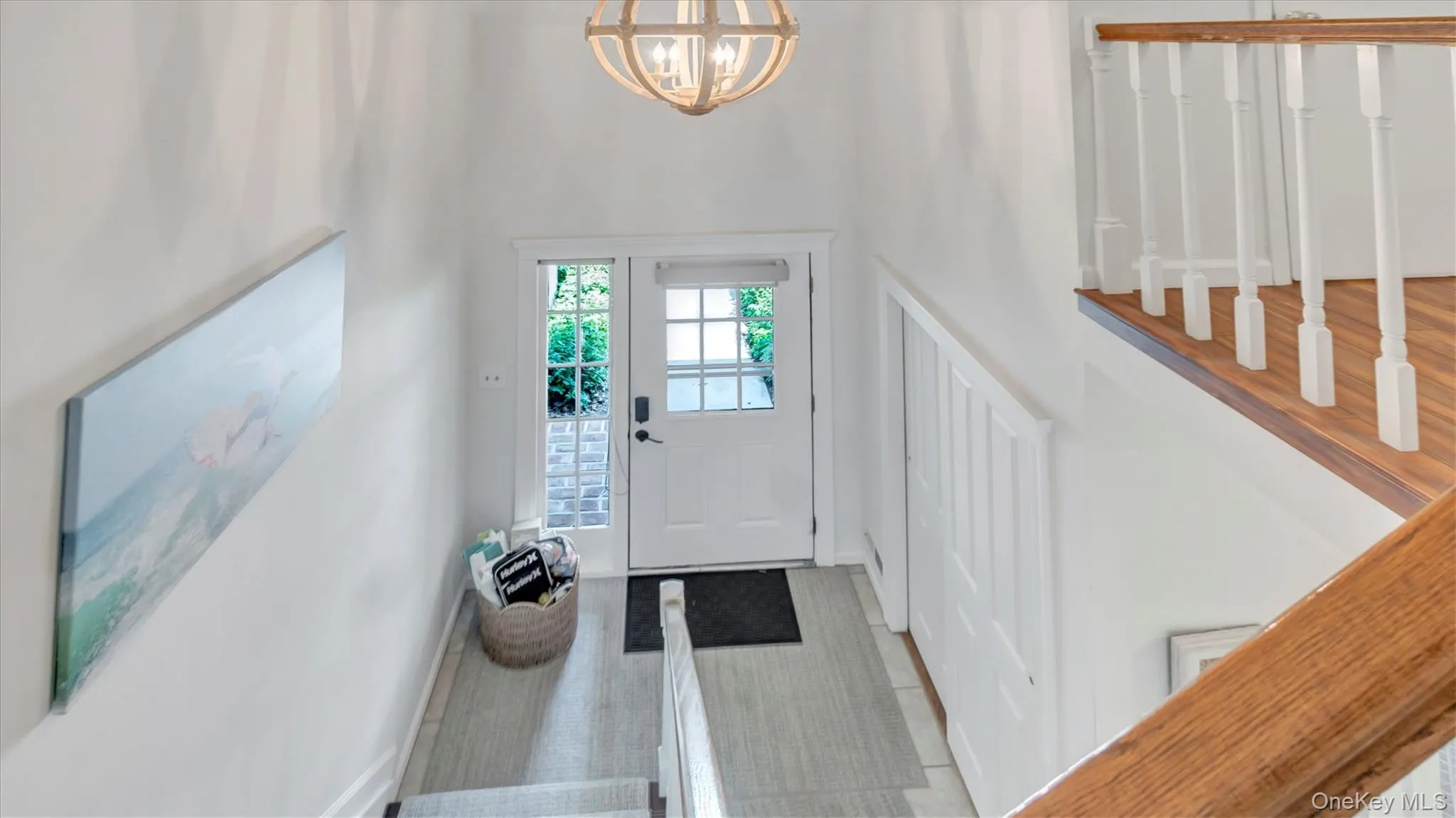 Foyer entrance featuring a chandelier and a high ceiling Foyer entrance featuring a chandelier and a high ceiling