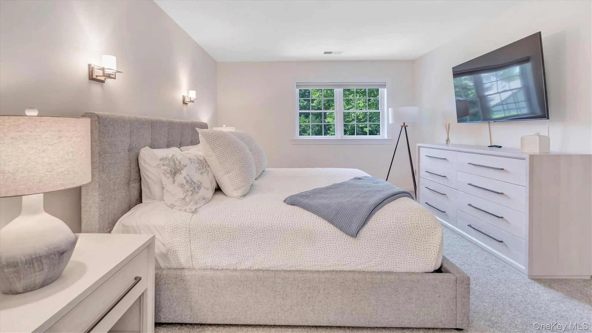 Primary on the upper level Bedroom featuring light carpet Primary on the upper level Bedroom featuring light carpet