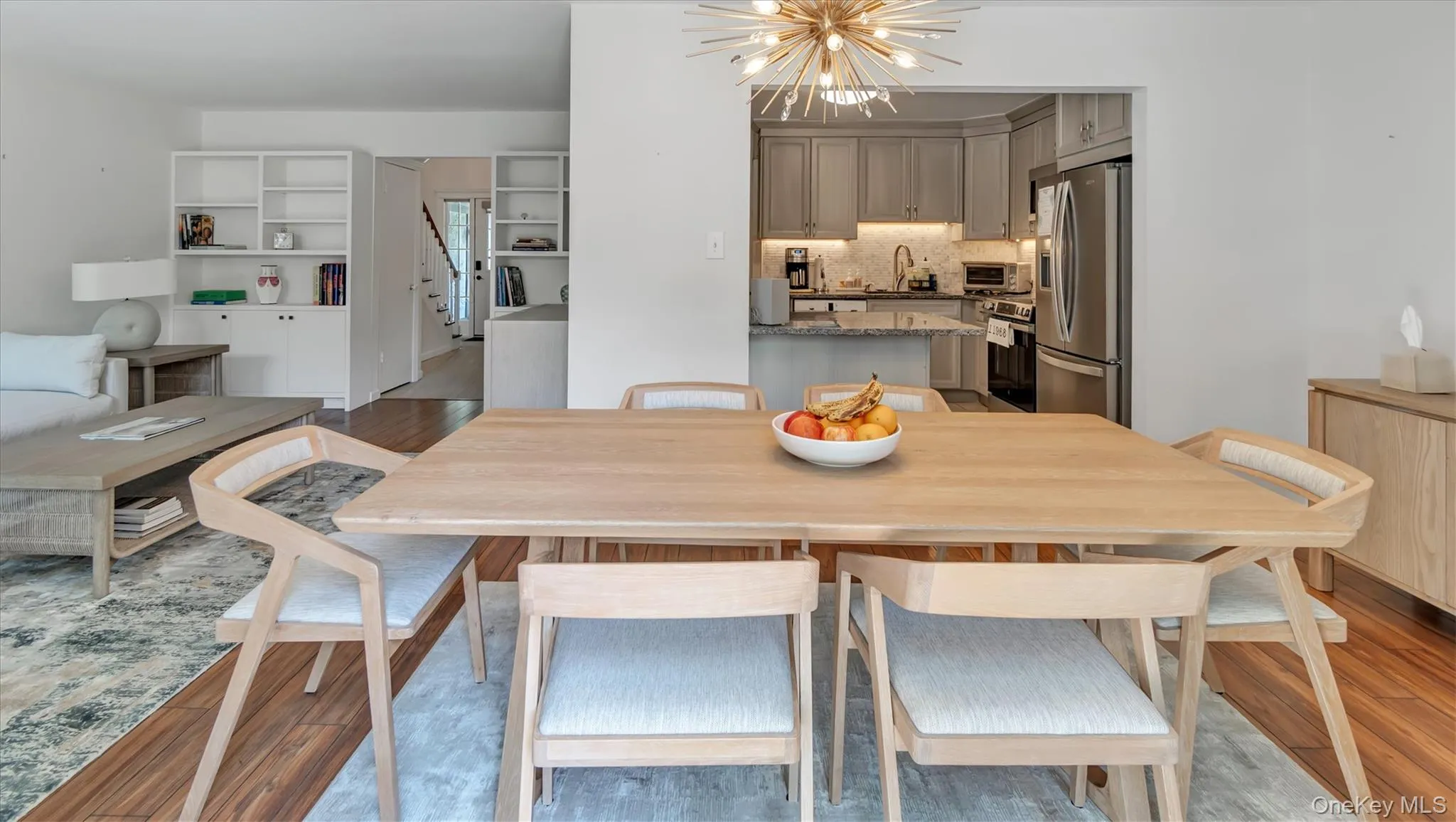 Dining area featuring a chandelier and light wood-type flooring Dining area featuring a chandelier and light wood-type flooring