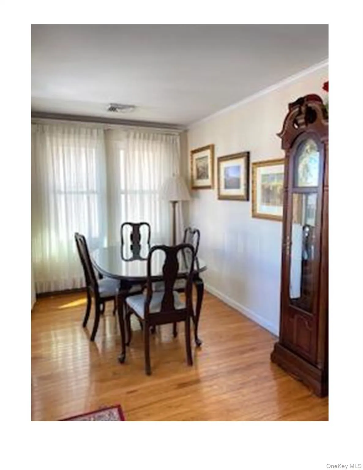 Dining area featuring ornamental molding and light wood-type flooring Dining area featuring ornamental molding and light wood-type flooring