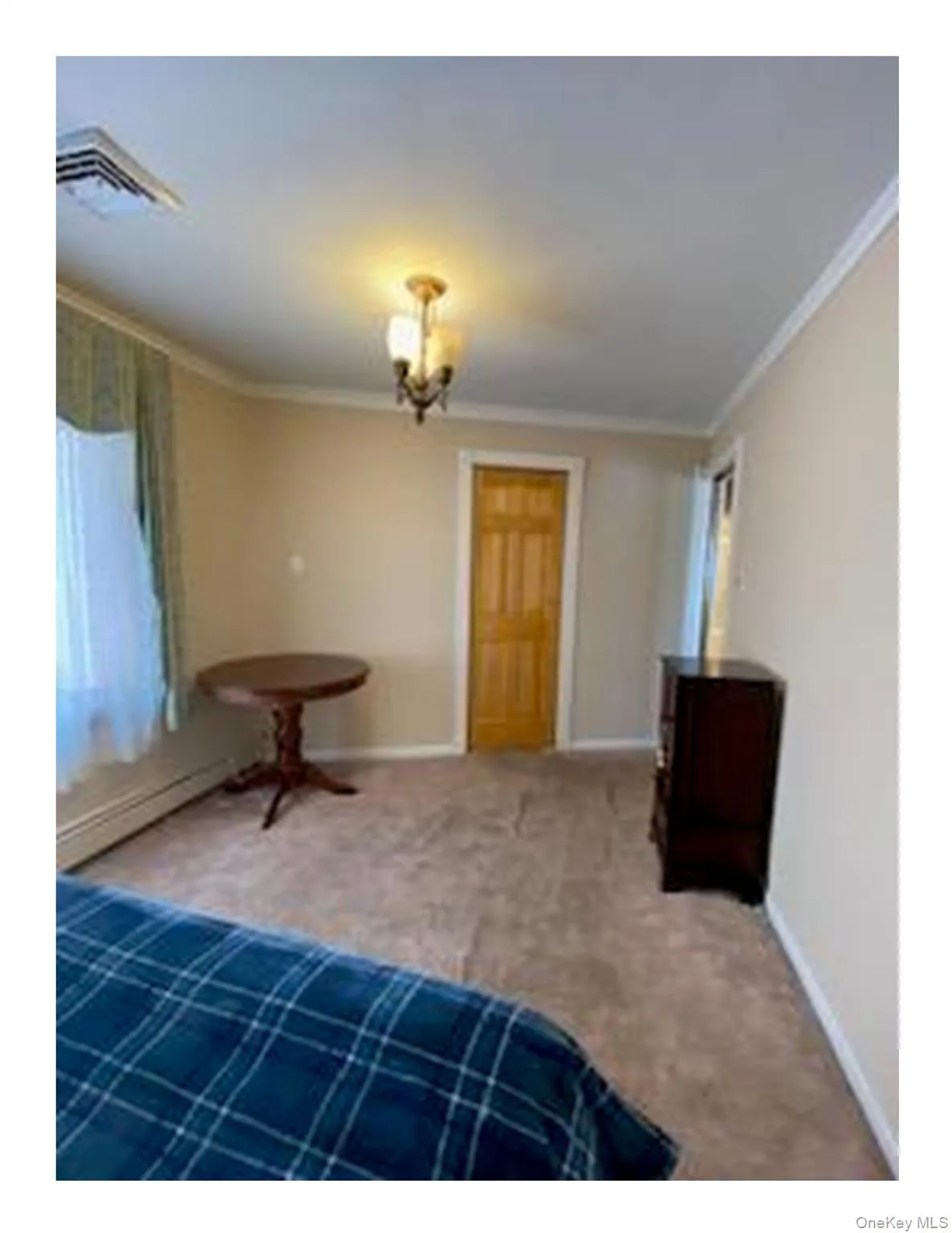 Unfurnished bedroom with ornamental molding and carpet flooring Unfurnished bedroom with ornamental molding and carpet flooring
