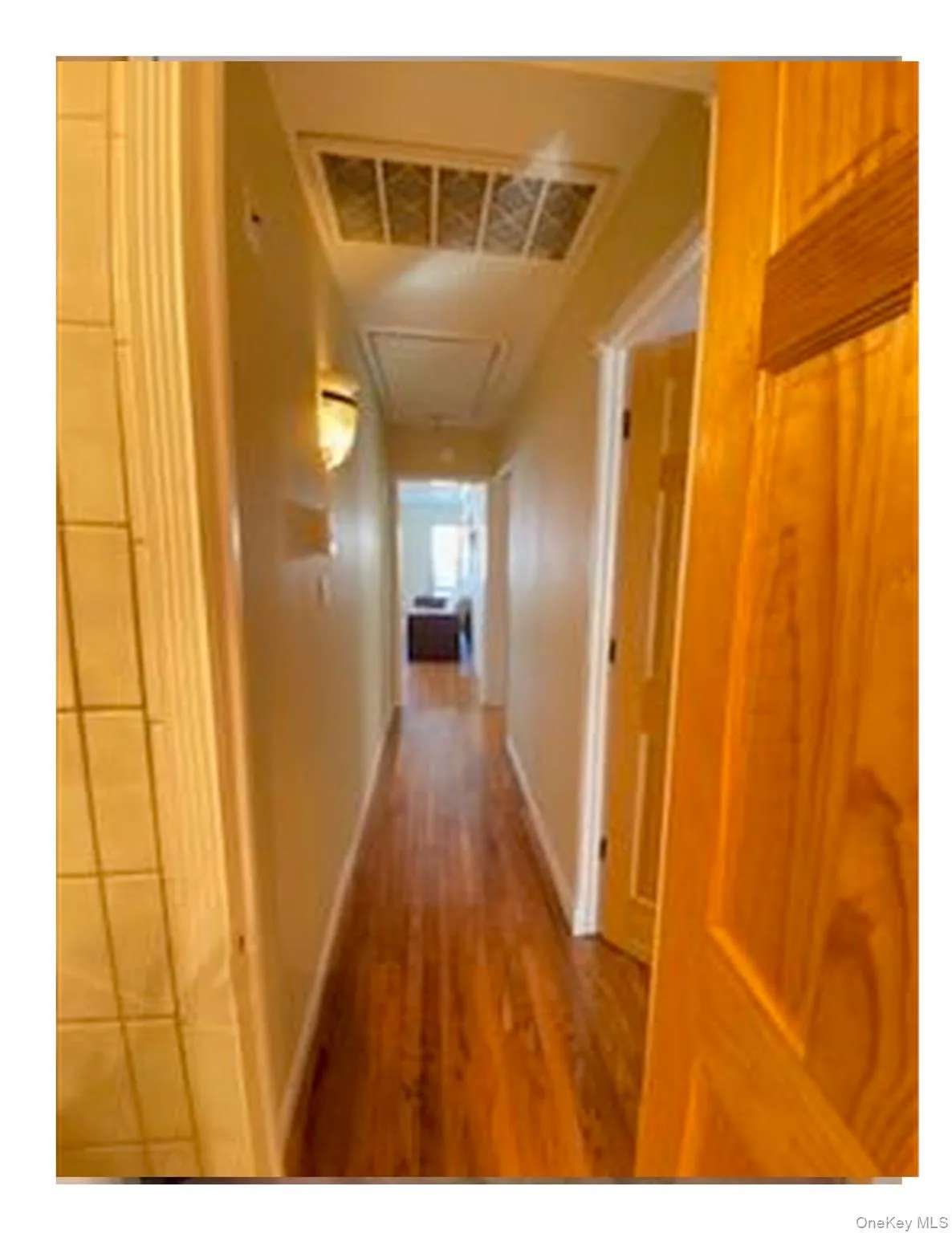 Hall with wood finished floors and baseboards Hall with wood finished floors and baseboards