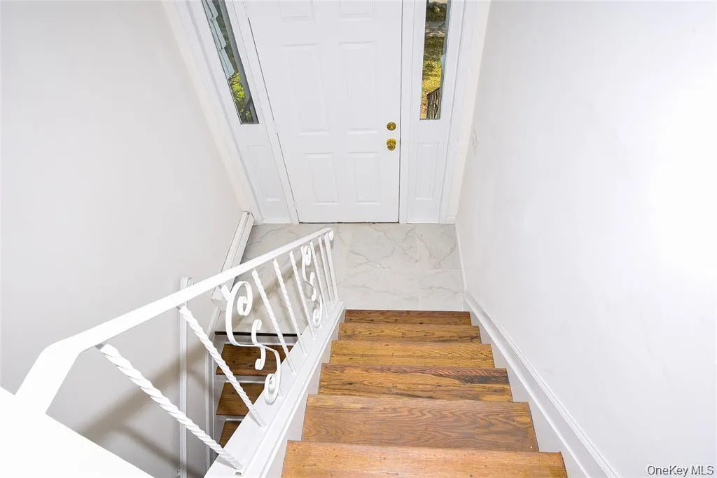 Stairs featuring wood finished floors Stairs featuring wood finished floors