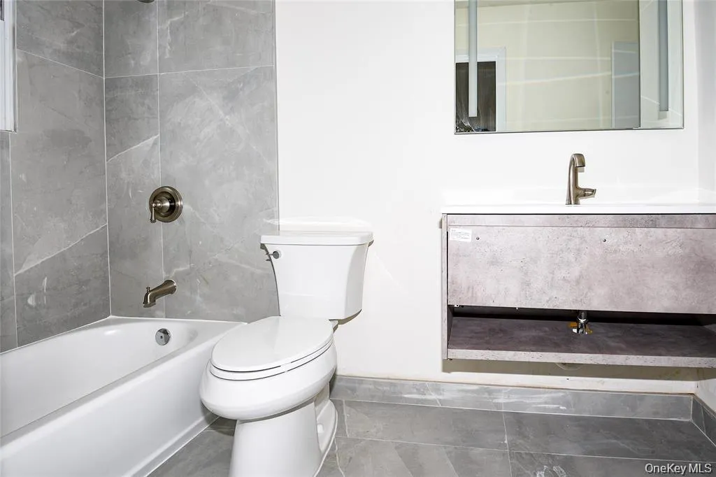 Bathroom with  shower combination, vanity, and tile patterned flooring Bathroom with  shower combination, vanity, and tile patterned flooring