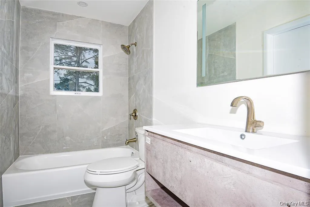 Full bathroom with vanity, shower / tub combination, and tile patterned floors Full bathroom with vanity, shower / tub combination, and tile patterned floors