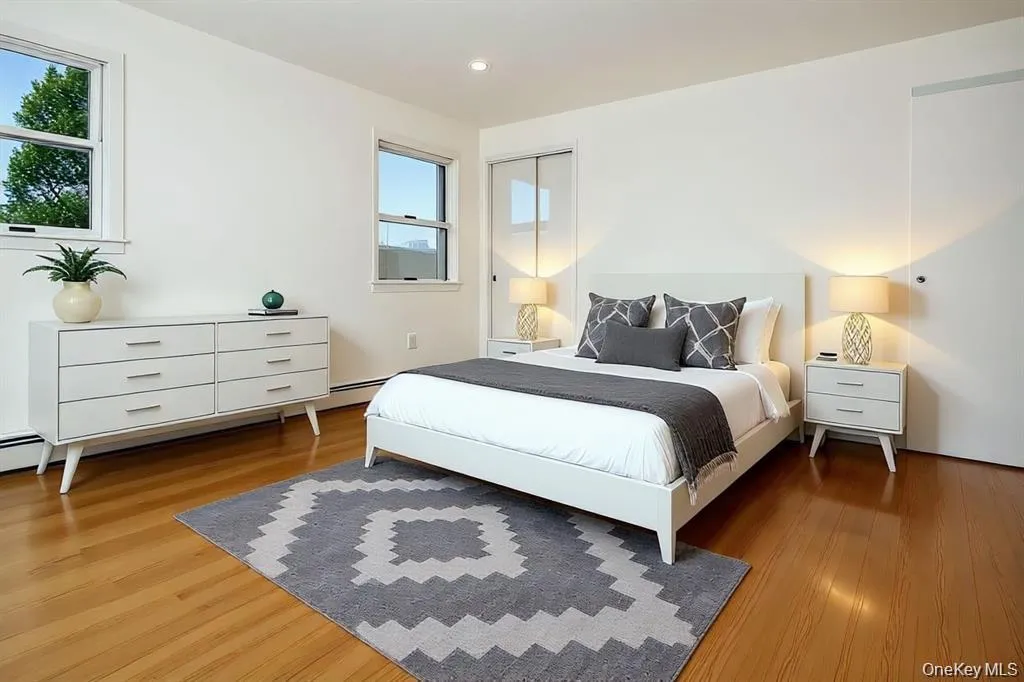 Bedroom with light wood-type flooring and recessed lighting Bedroom with light wood-type flooring and recessed lighting