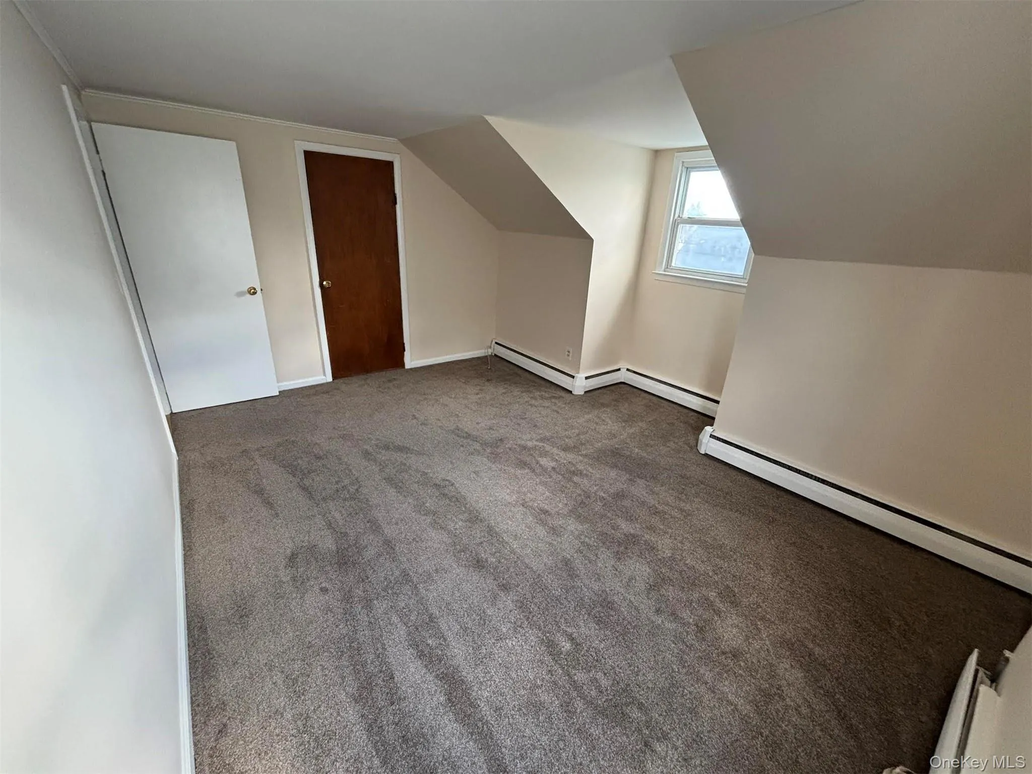 Bonus room featuring carpet floors, a baseboard heating unit, and lofted ceiling Bonus room featuring carpet floors, a baseboard heating unit, and lofted ceiling