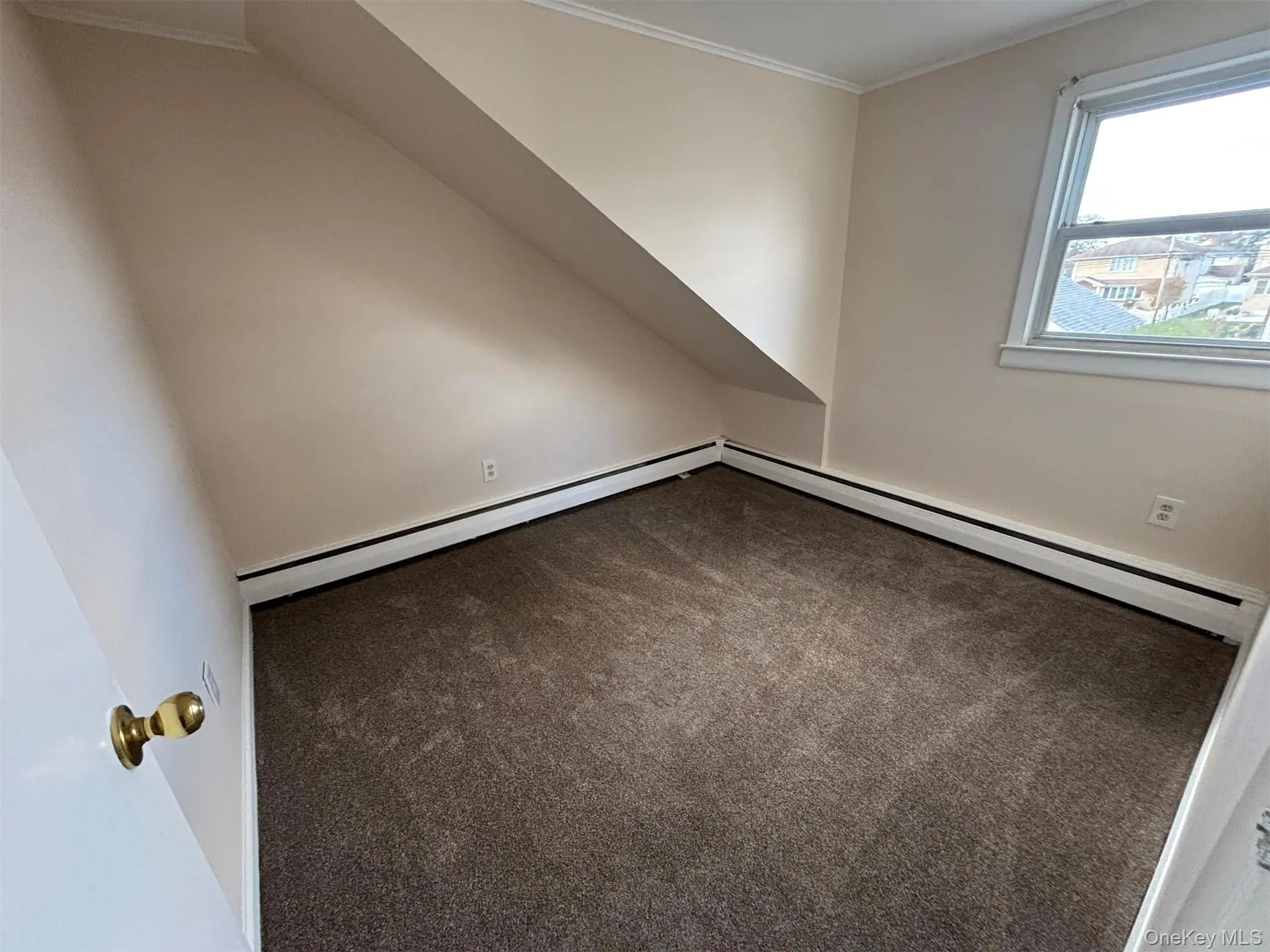 Bonus room featuring carpet floors and a baseboard heating unit Bonus room featuring carpet floors and a baseboard heating unit