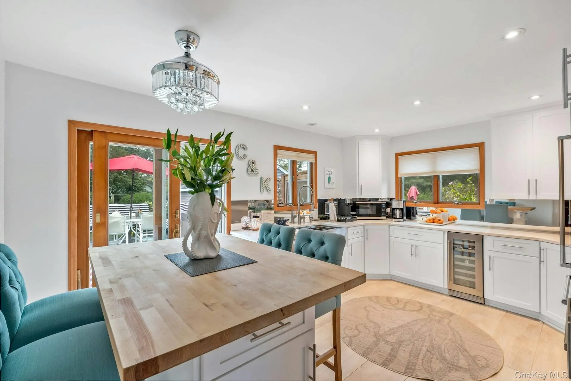 Kitchen featuring white cabinetry, healthy amount of natural light, recessed lighting, and wine cooler Kitchen featuring white cabinetry, healthy amount of natural light, recessed lighting, and wine cooler