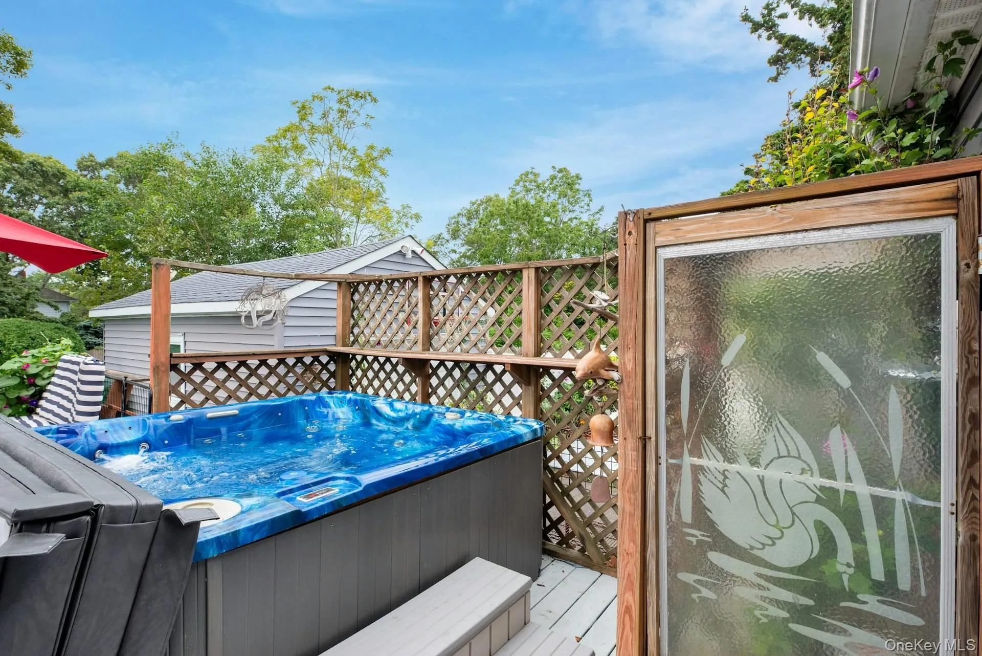 Deck featuring a hot tub Deck featuring a hot tub