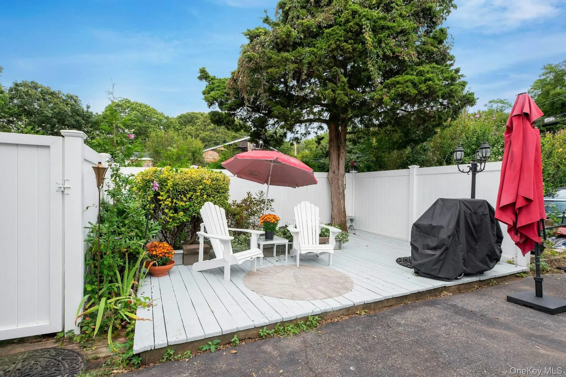 Wooden deck featuring a fenced backyard and a grill Wooden deck featuring a fenced backyard and a grill