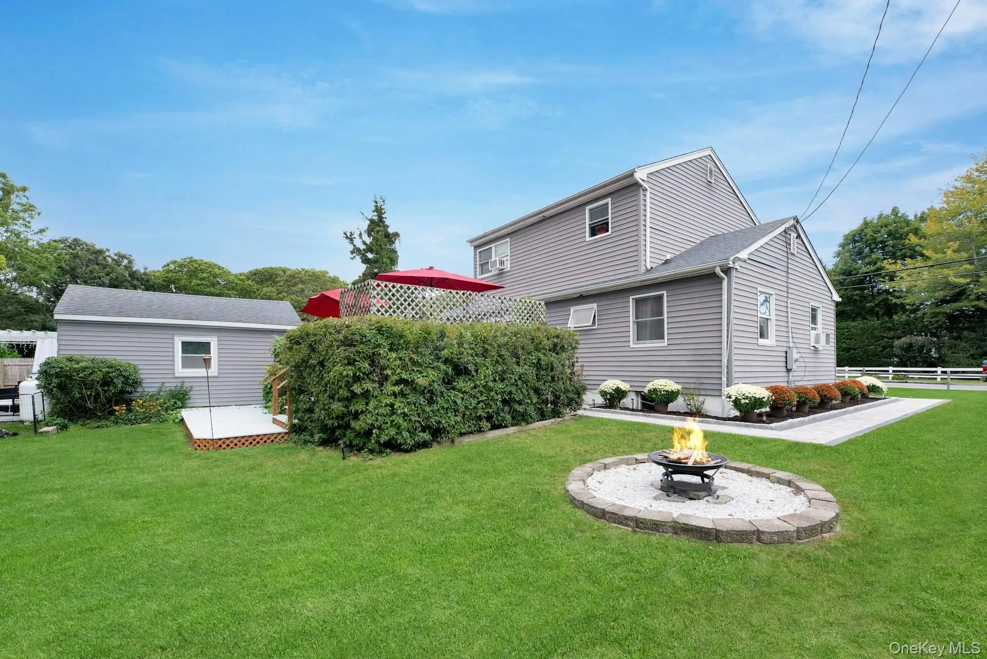 Back of house featuring a fire pit and a patio area Back of house featuring a fire pit and a patio area