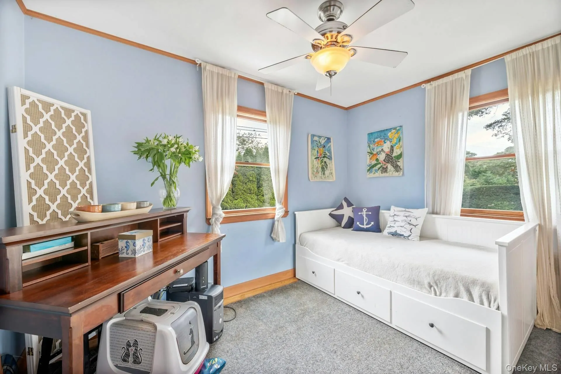 Carpeted bedroom featuring ornamental molding and ceiling fan Carpeted bedroom featuring ornamental molding and ceiling fan