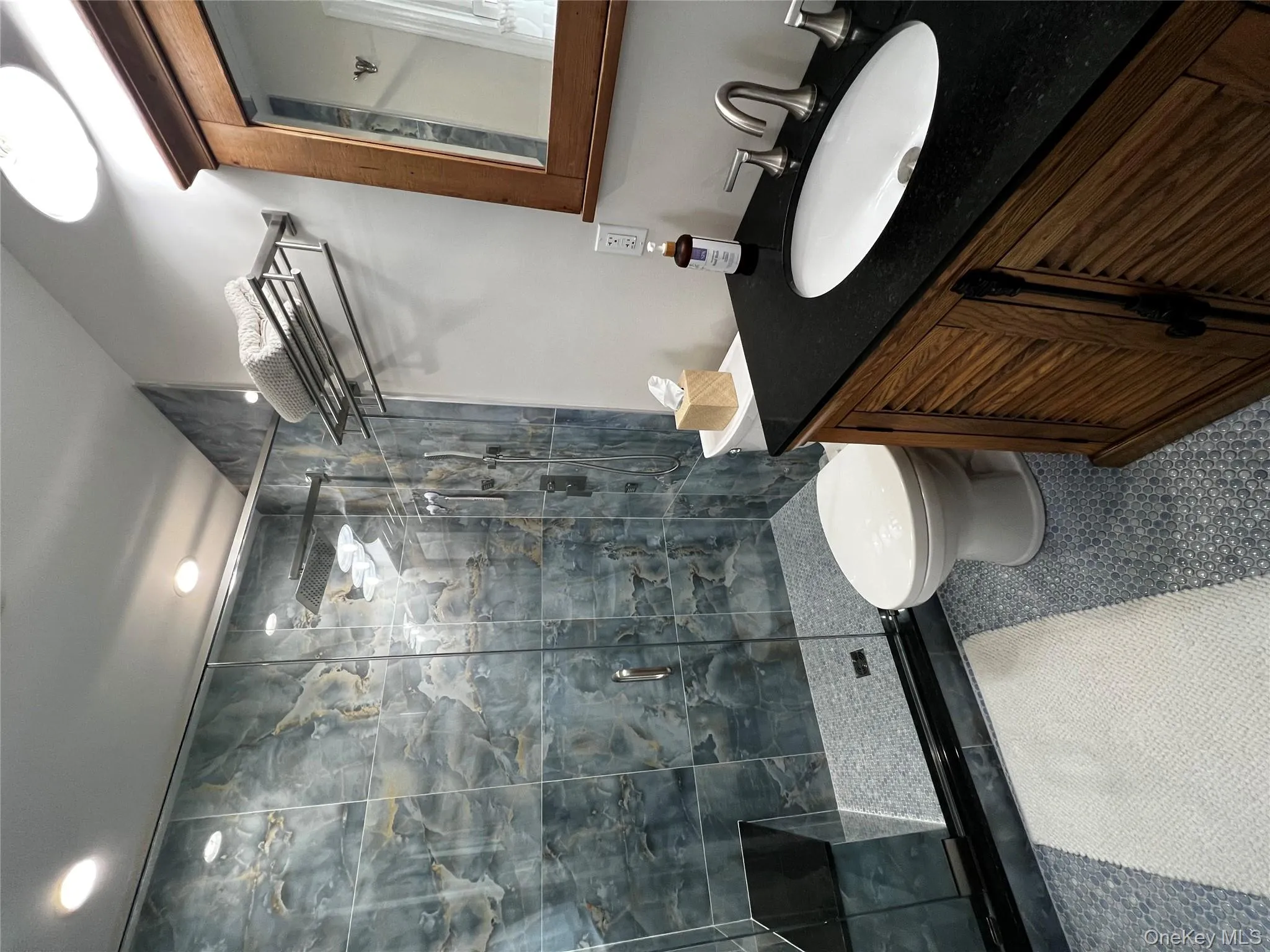 Bathroom with vanity, tile patterned flooring, and a stall shower Bathroom with vanity, tile patterned flooring, and a stall shower