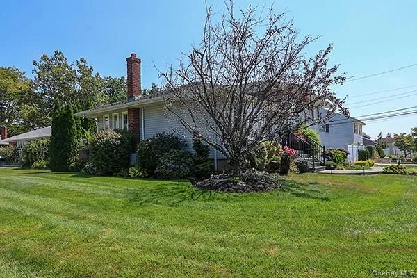 View of home's exterior with a chimney and a yard View of home's exterior with a chimney and a yard