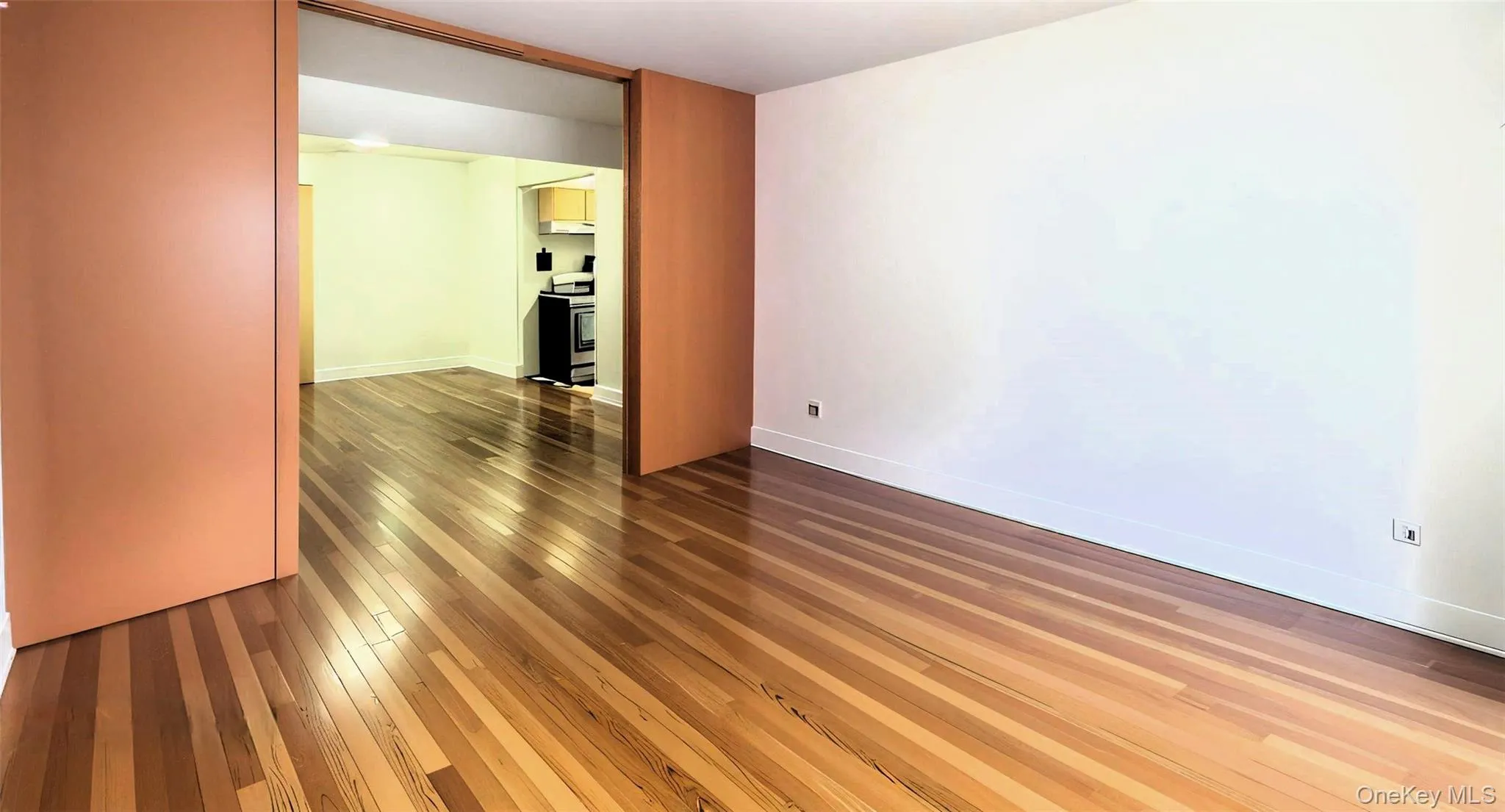 Spare room featuring dark wood finished floors and baseboards Spare room featuring dark wood finished floors and baseboards