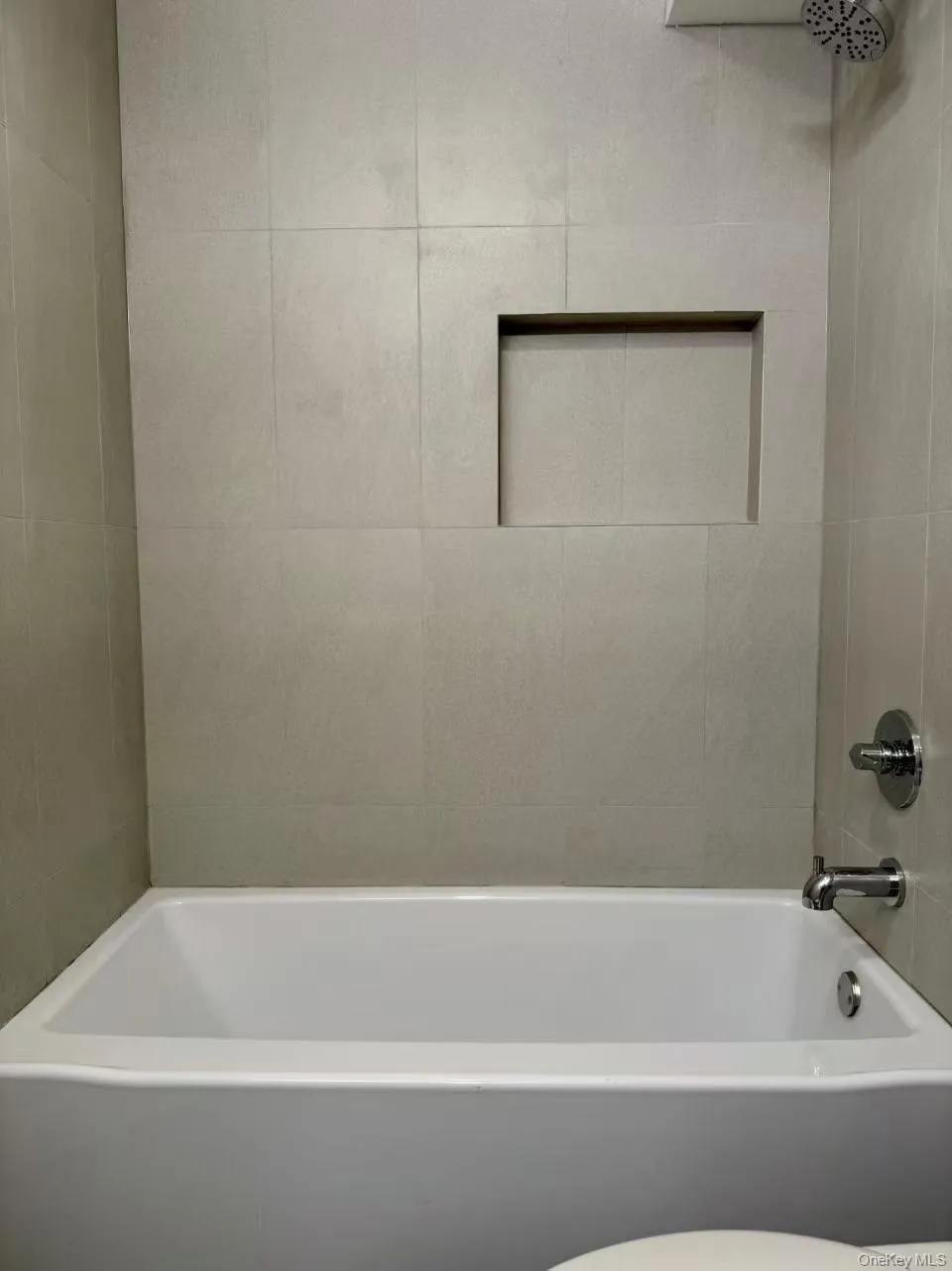 Full bathroom featuring shower / bath combination and toilet Full bathroom featuring shower / bath combination and toilet