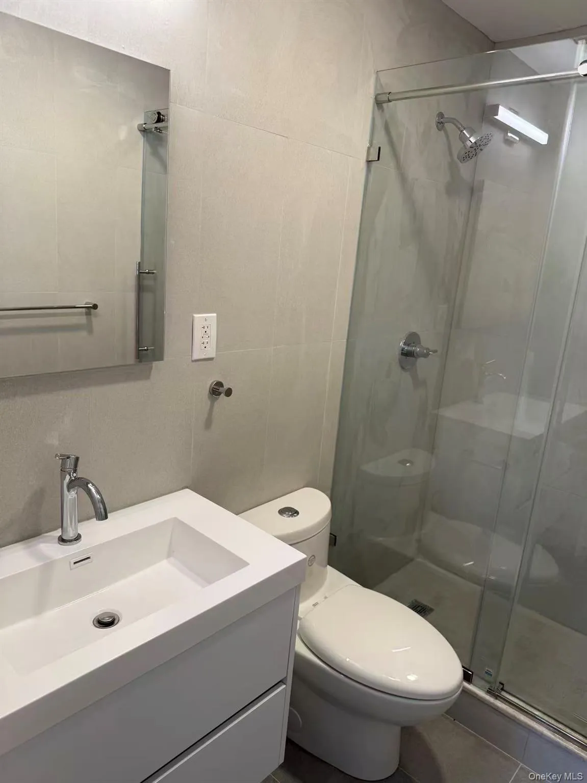 Full bathroom featuring a shower stall and vanity Full bathroom featuring a shower stall and vanity