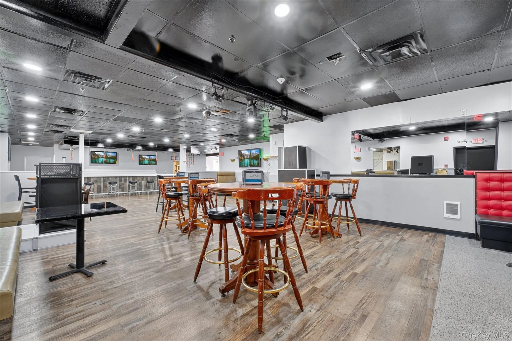 Dining room with wood finished floors and a paneled ceiling Dining room with wood finished floors and a paneled ceiling