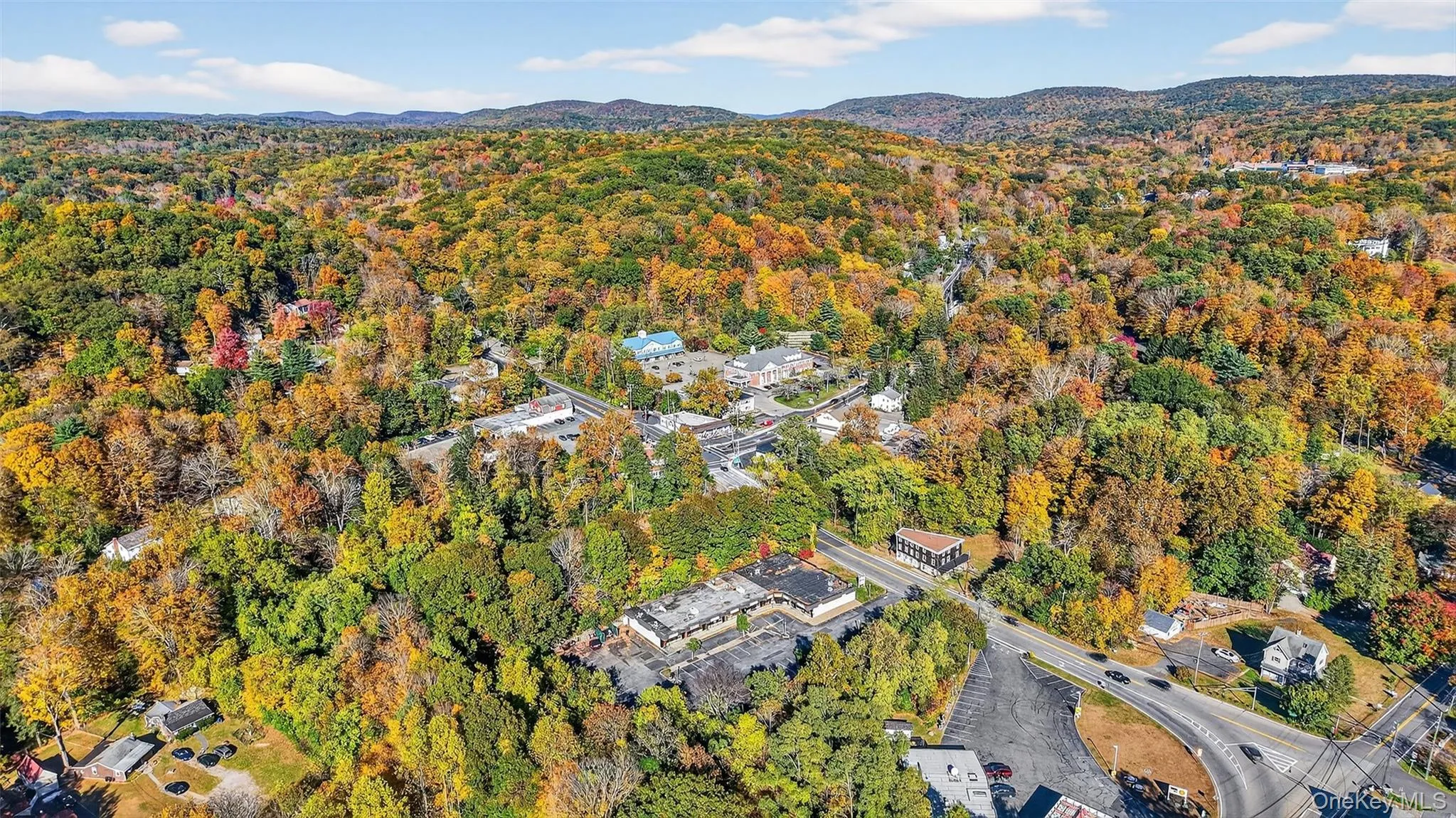 Aerial view of property and surrounding area with a heavily wooded area Aerial view of property and surrounding area with a heavily wooded area