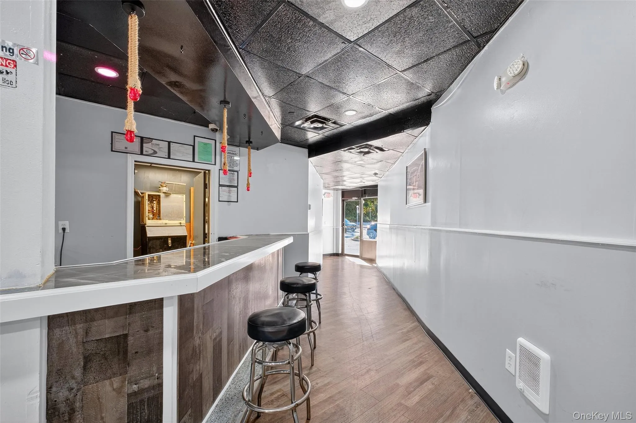 Indoor dry bar featuring a paneled ceiling and recessed lighting Indoor dry bar featuring a paneled ceiling and recessed lighting