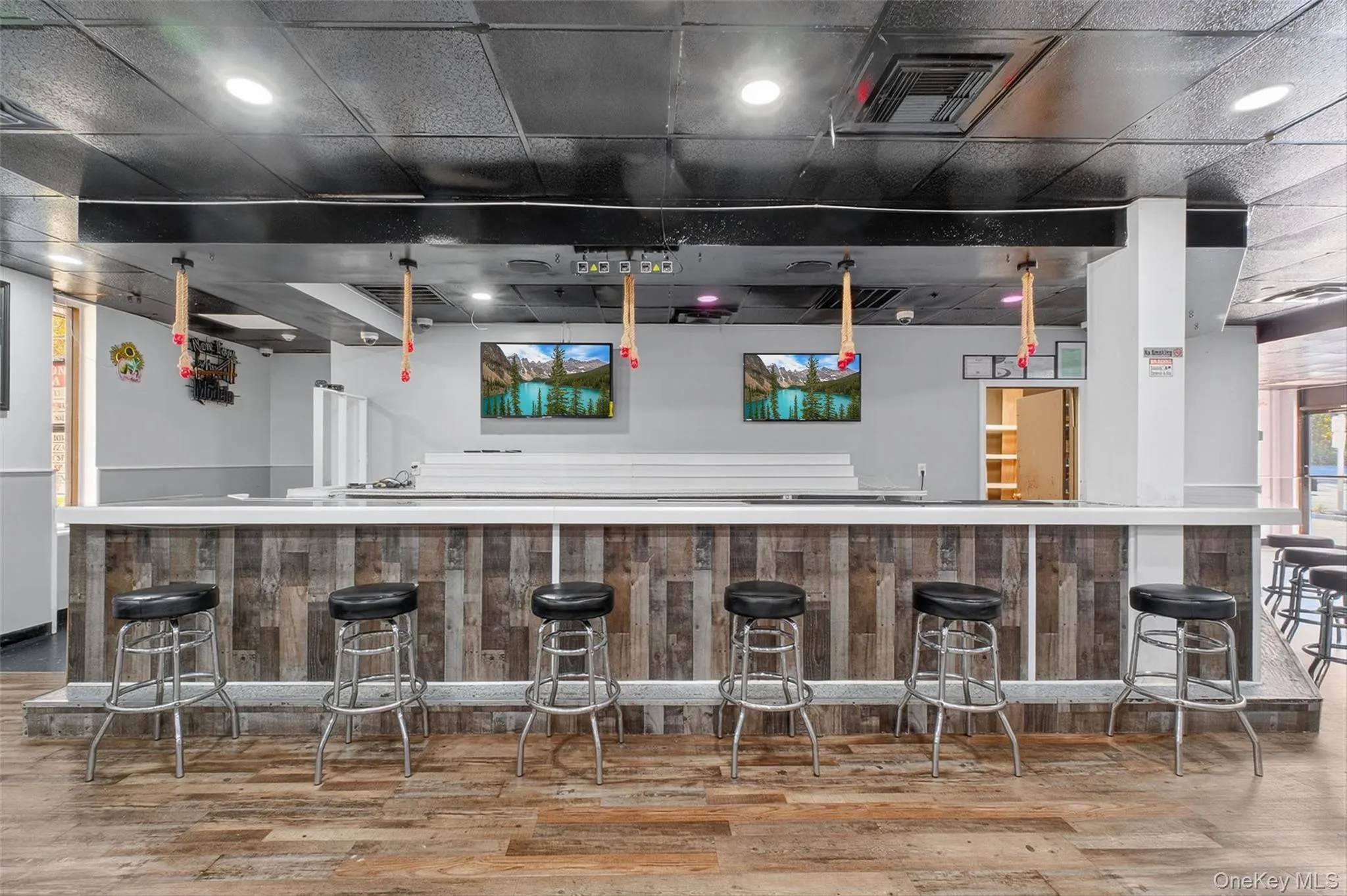 Indoor wet bar featuring recessed lighting and light countertops Indoor wet bar featuring recessed lighting and light countertops