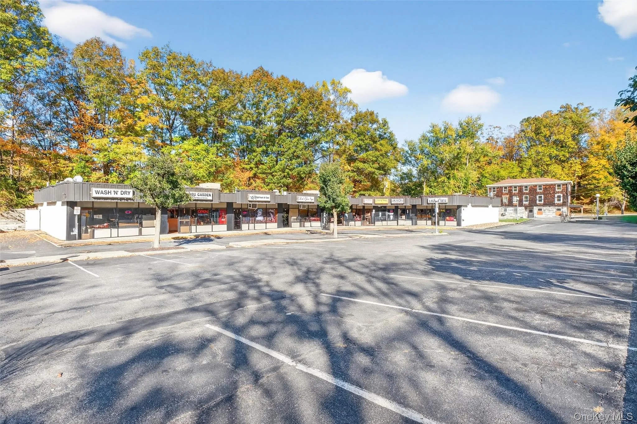View of commercial property with uncovered parking View of commercial property with uncovered parking